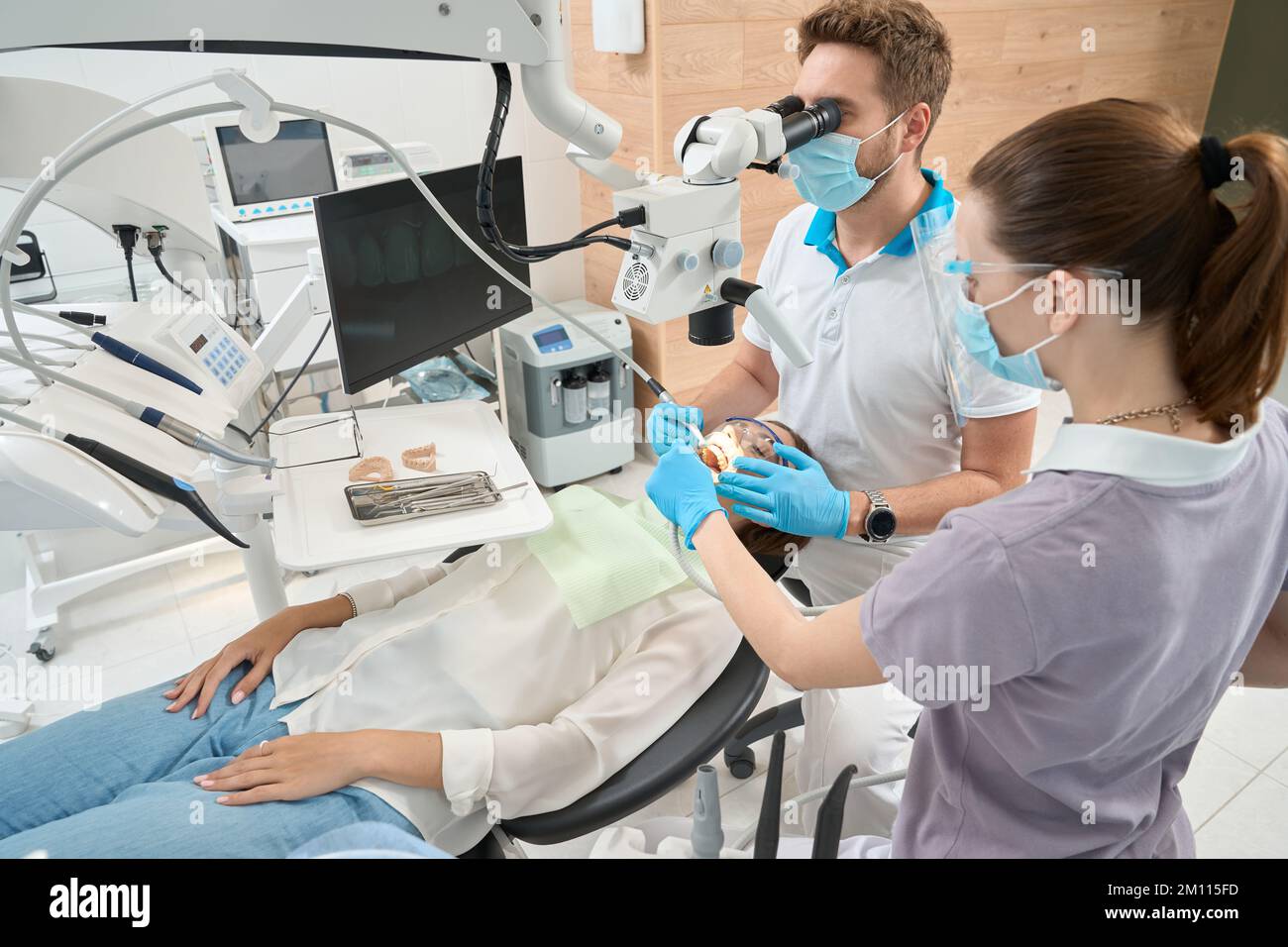 Dental hygienist carrying out interdental calculus removal under