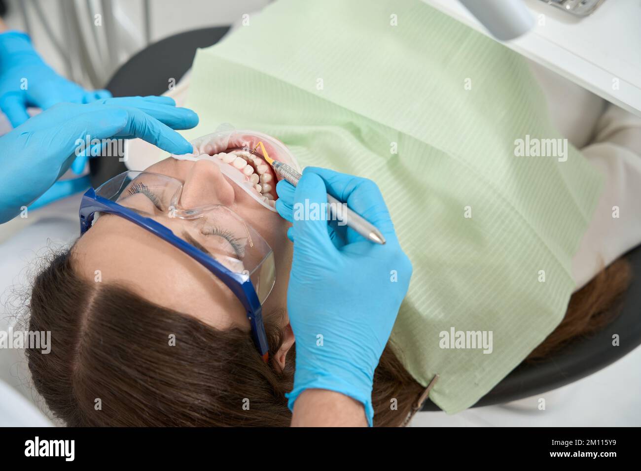 Doctor performing hand scaling procedure on female patient Stock Photo