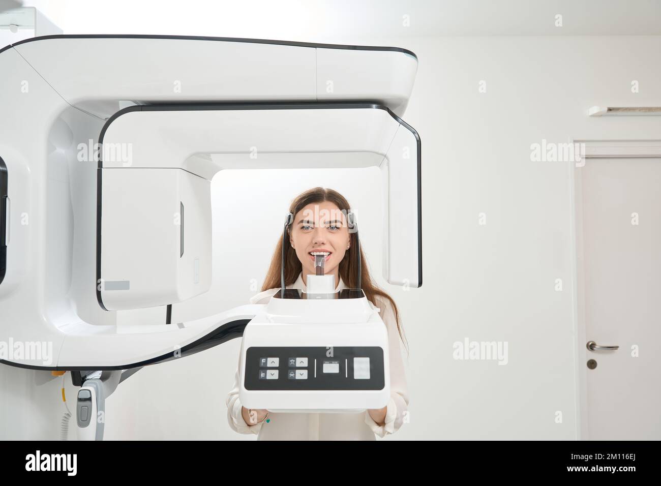 Female patient having her teeth scanned with tomograph Stock Photo