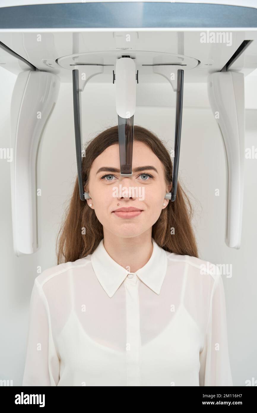 Dental clinic patient undergoing diagnostic examination on tomograph Stock Photo