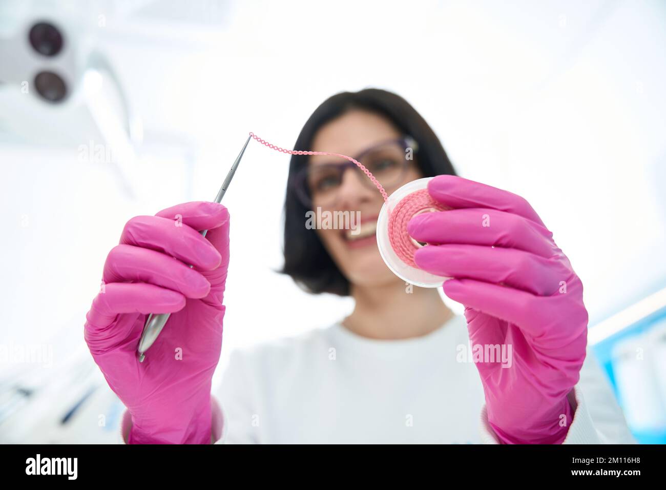 Woman dentist holds materials and instruments for orthodontics in hands Stock Photo