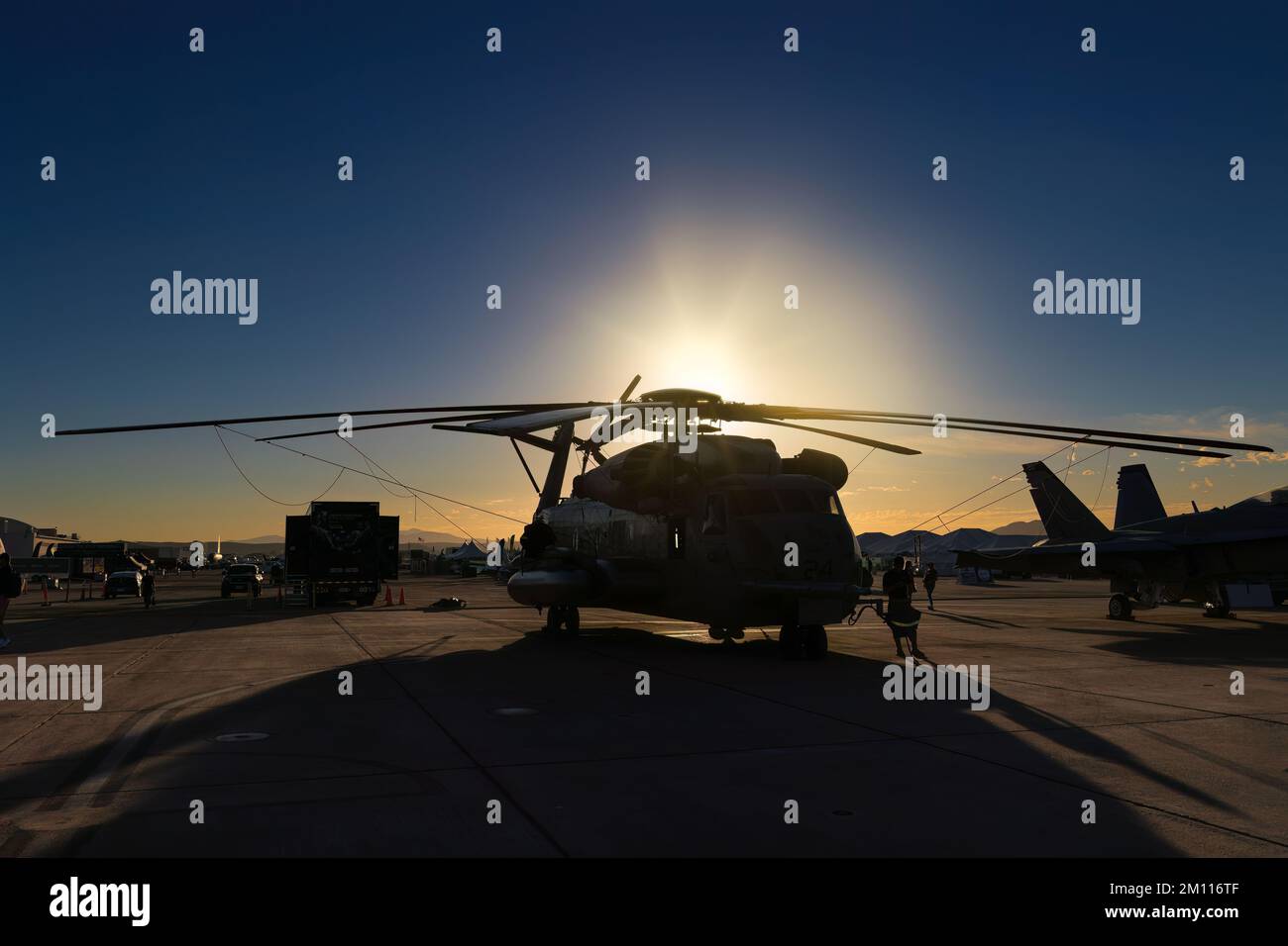 The silhouette of a CH-53 Sea Stallion helicopter as the sun rises from behind at the 2022 Miramar Airshow in San Diego, California. Stock Photo