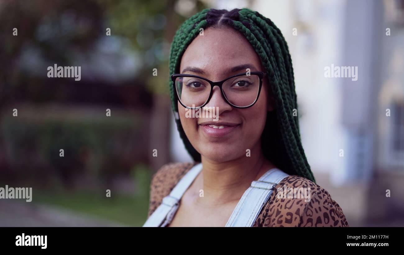 Portrait of a smiling Brazilian young black woman with braided hair ...