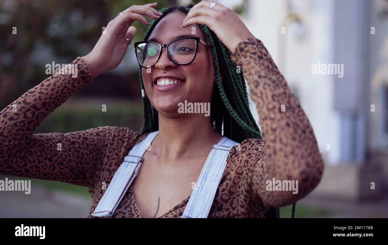 Portrait of a smiling Brazilian young black woman with braided hair ...