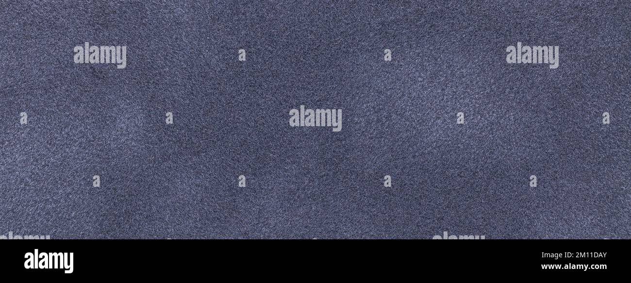 Background of dark gray suede fabric closeup. Velvet matt texture of blue nubuck textile. Stock Photo