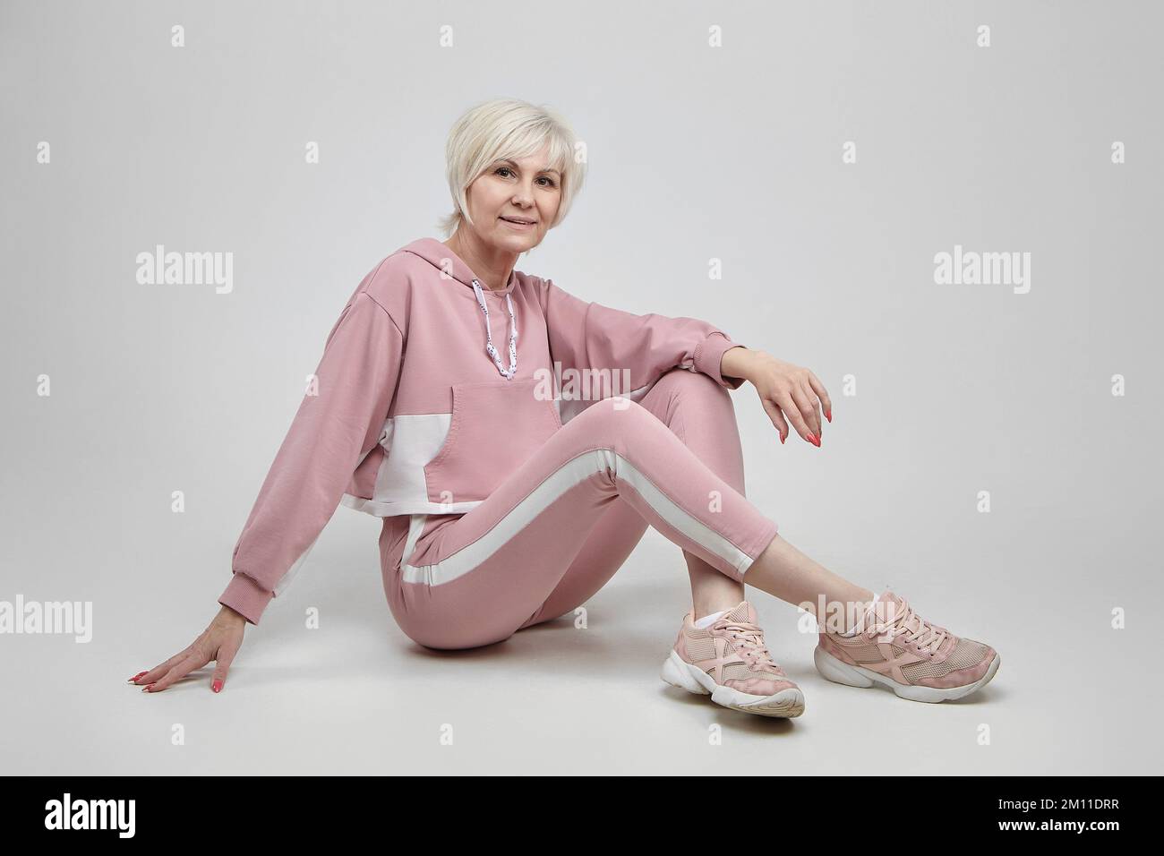 active elderly woman poses in the studio on a white background. fitness concept. Stock Photo