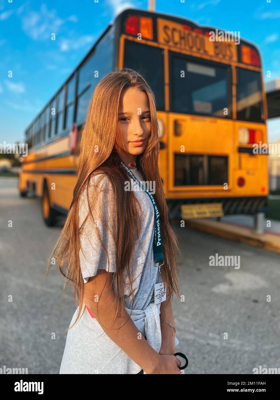 Beautiful teen girl getting on school bus Stock Photo Alamy