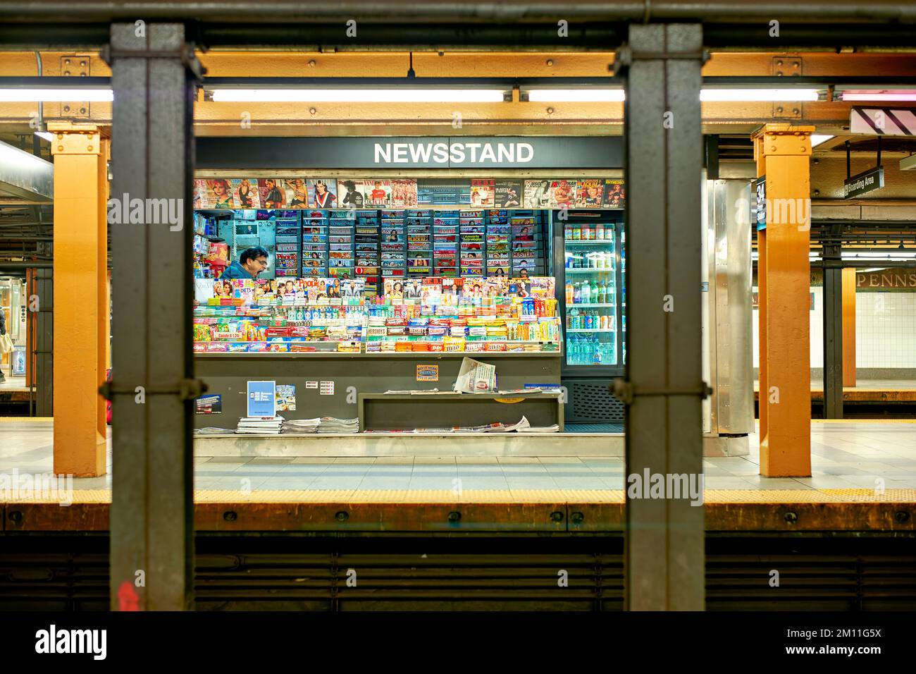 New York. Manhattan. United States. Newsstand in a subway station. Bored newsagent yawning Stock Photo