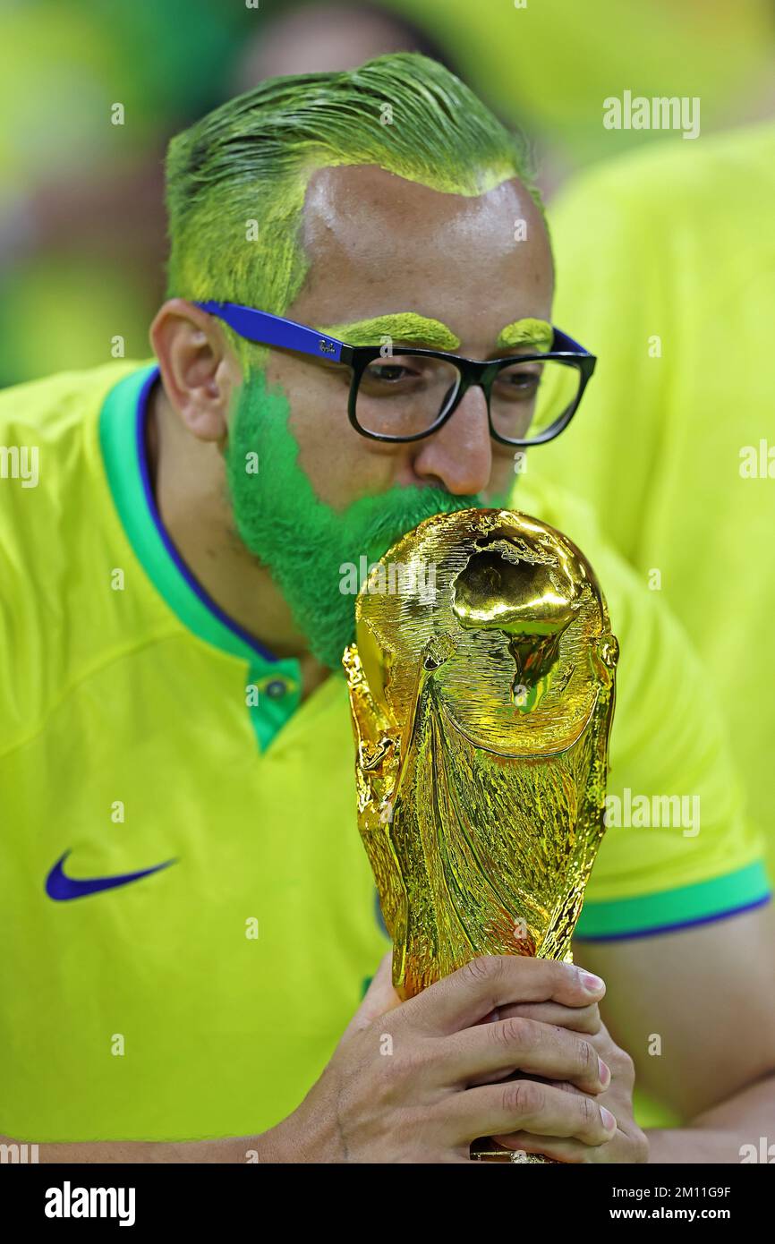 Brazil fan kisses the World Cup trophy during the FIFA World Cup Qatar 2022 match, Quarter Final, between Croatia v Brazil played at Education City Stadium on Dec 9, 2022 in Doha, Qatar. (Photo by Heuler Andrey / DiaEsportivo / PRESSIN) Stock Photo