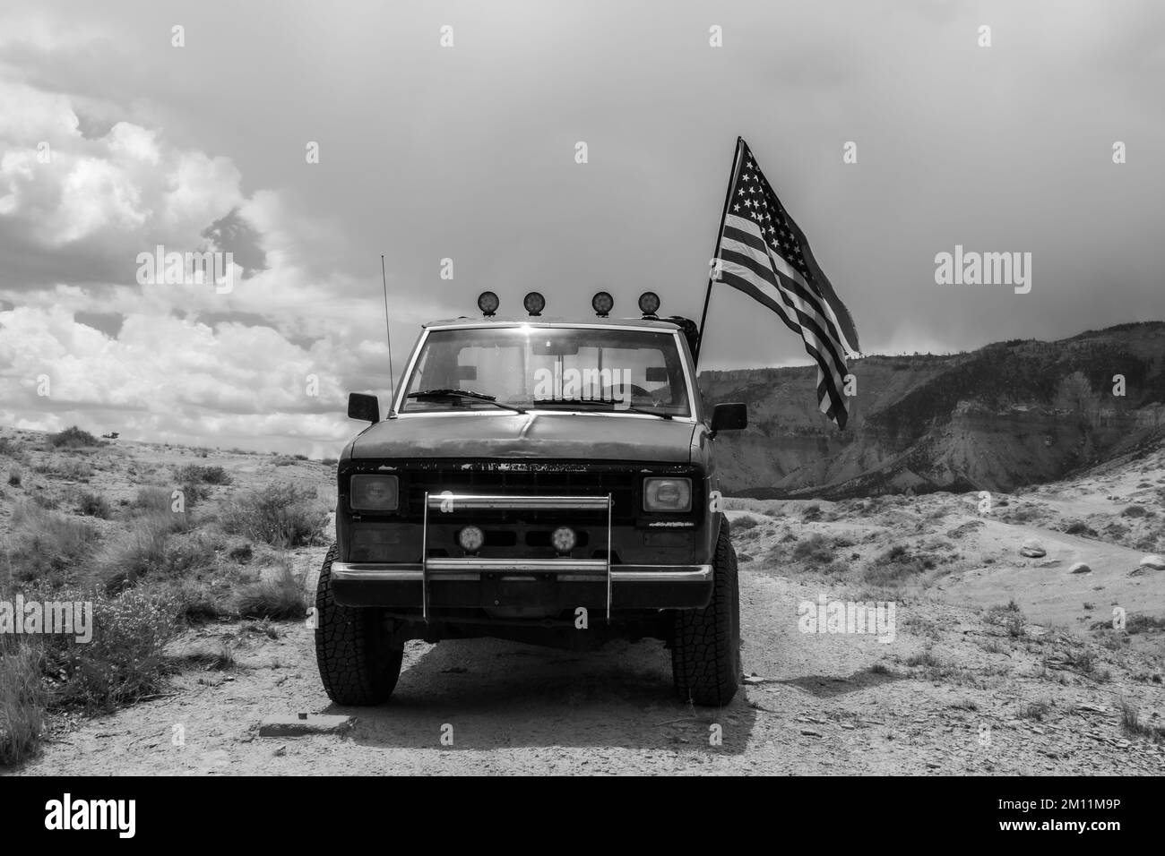 Black and White Truck with the American Flag flying Stock Photo