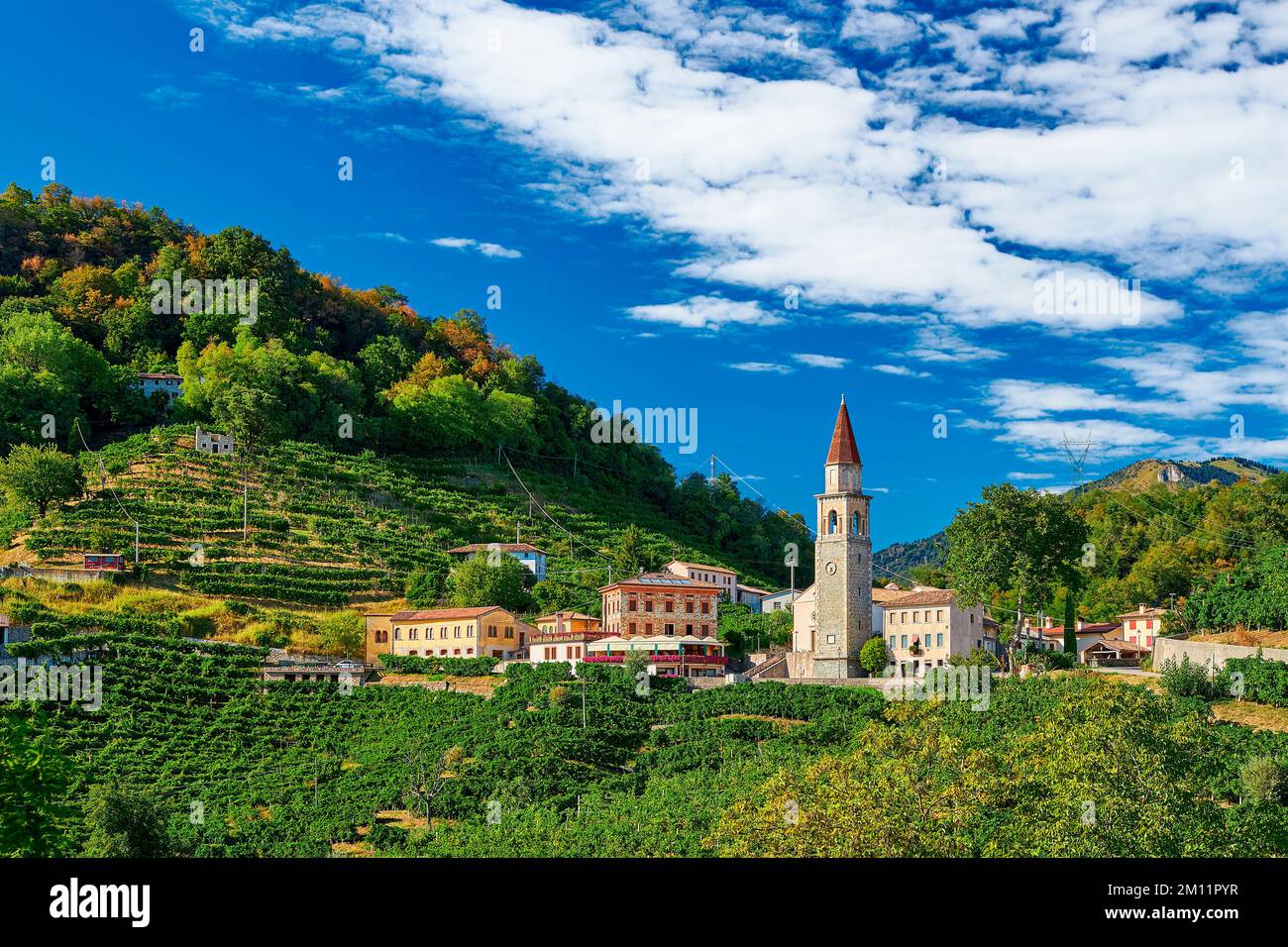 A church tower rises in the middle of a dreamlike landscape, Veneto, Northern Italy Stock Photo