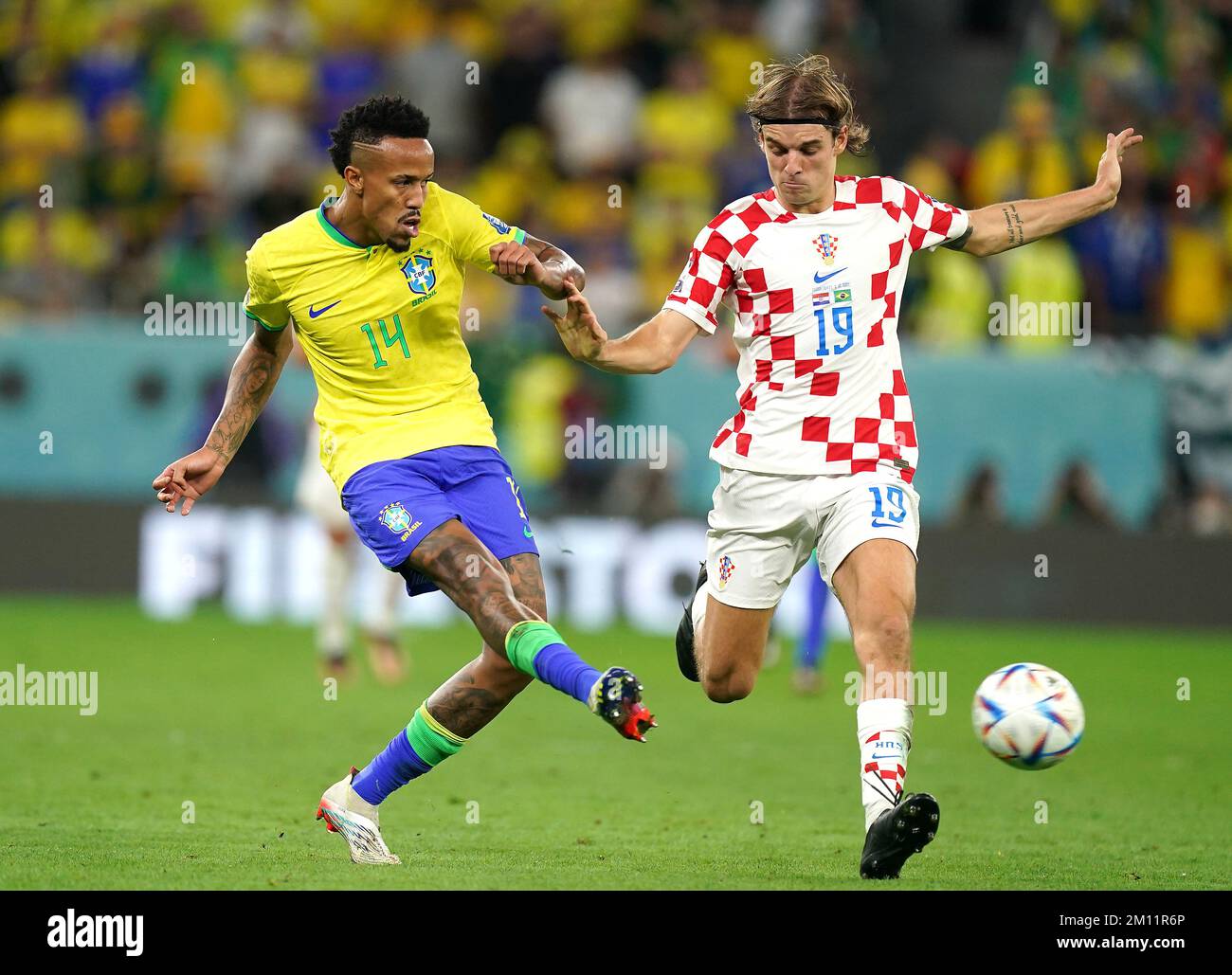 Brazil's Eder Militao (left) and Croatia's Borna Sosa battle for the ball during the FIFA World Cup Quarter-Final match at the Education City Stadium in Al Rayyan, Qatar. Picture date: Friday December 9, 2022. Stock Photo