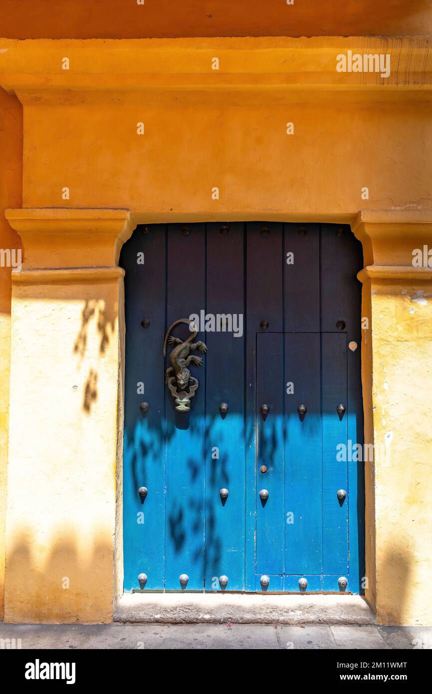 South America, Colombia, Departamento de Bolívar, Cartagena de Indias, Ciudad Amurallada, Blue door in historical orange facade Stock Photo