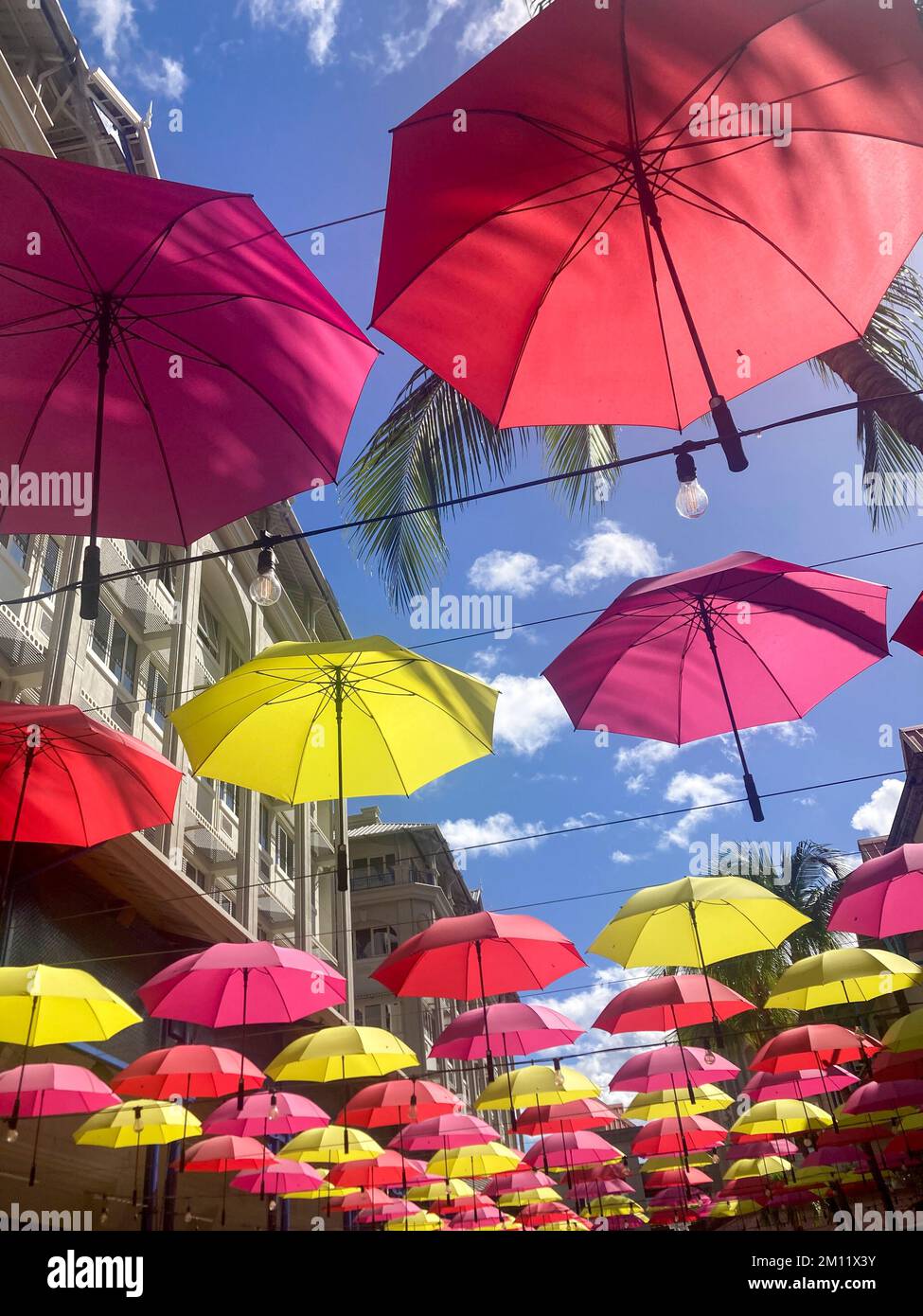 Umbrellas lining caudan waterfront commercial development in port louis hires stock photography