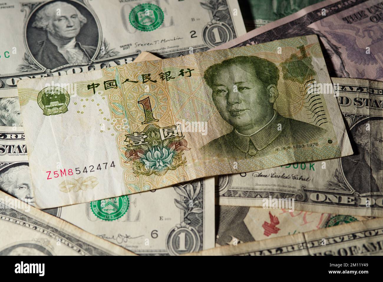 One Chinese yuan bank note on USA dollars background Stock Photo