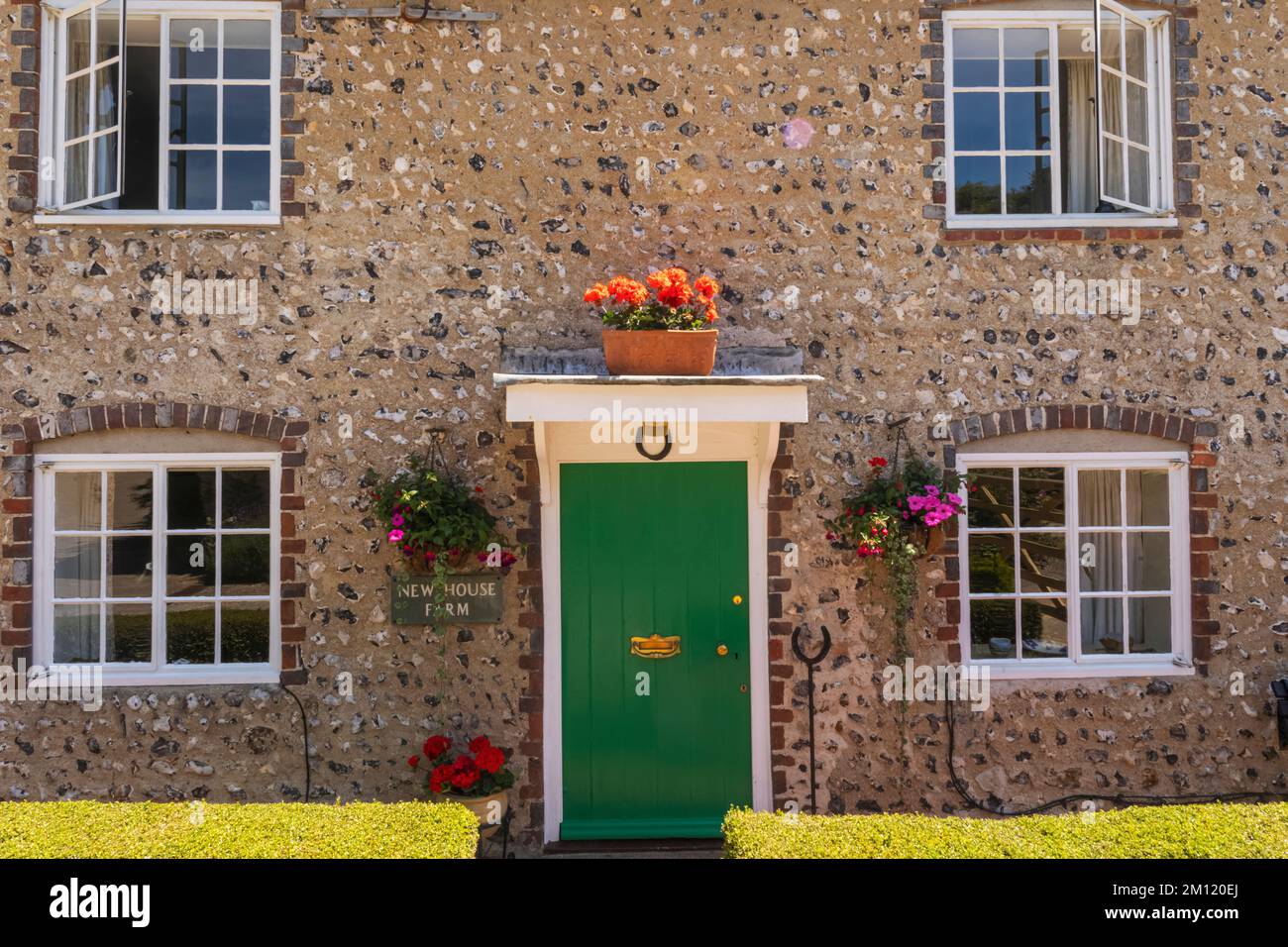 England, East Sussex, Eastbourne, East Dean Village, Colourful Door and Traditional Flint House Facade Stock Photo