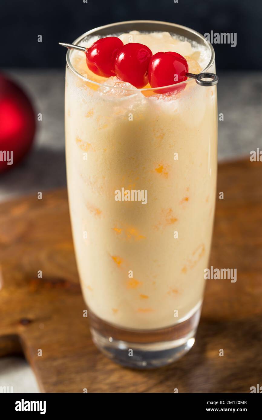 Cold Refreshing Advocaat Snowball Cocktail with Lemon and Cherry Stock