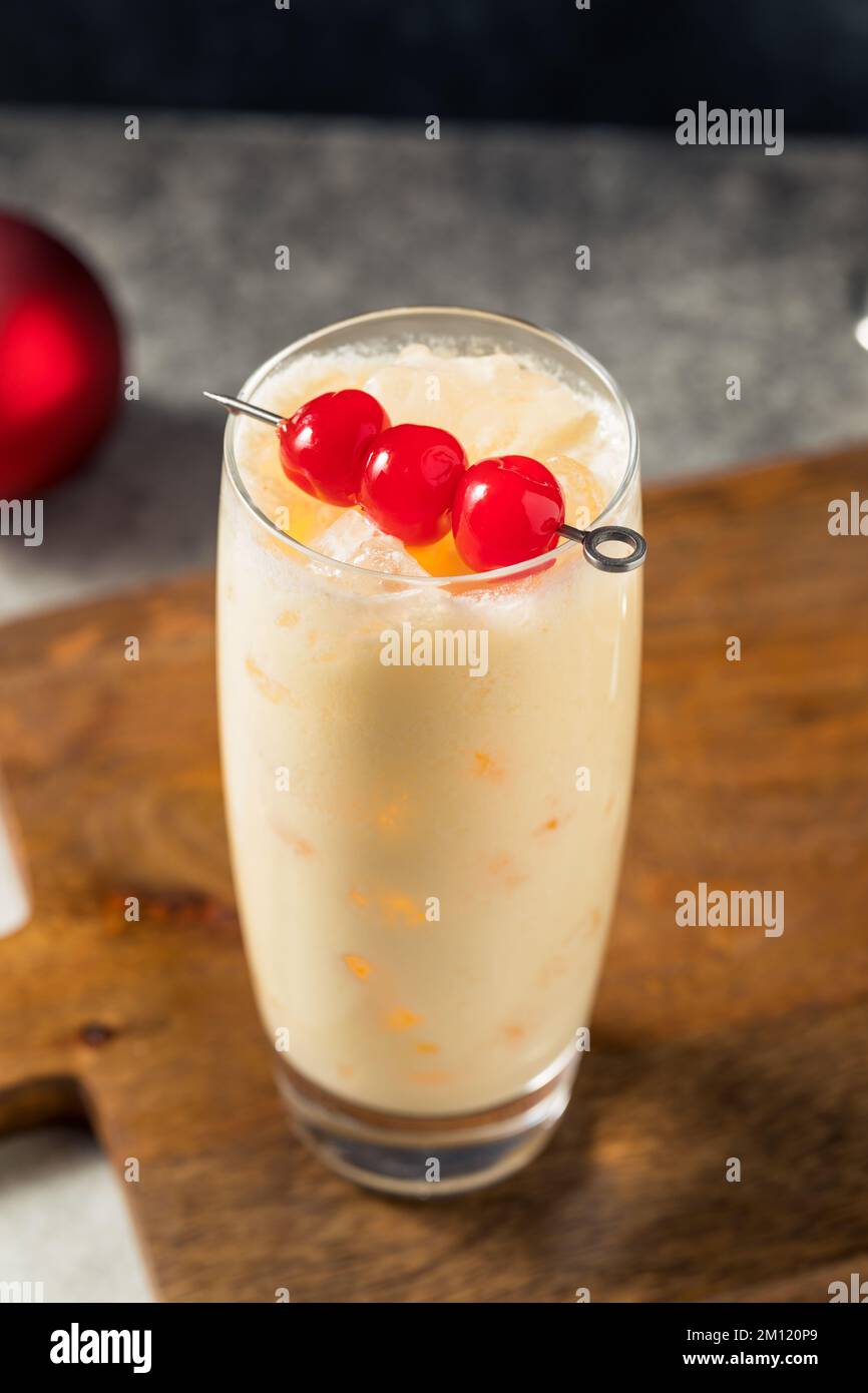 Cold Refreshing Advocaat Snowball Cocktail with Lemon and Cherry Stock