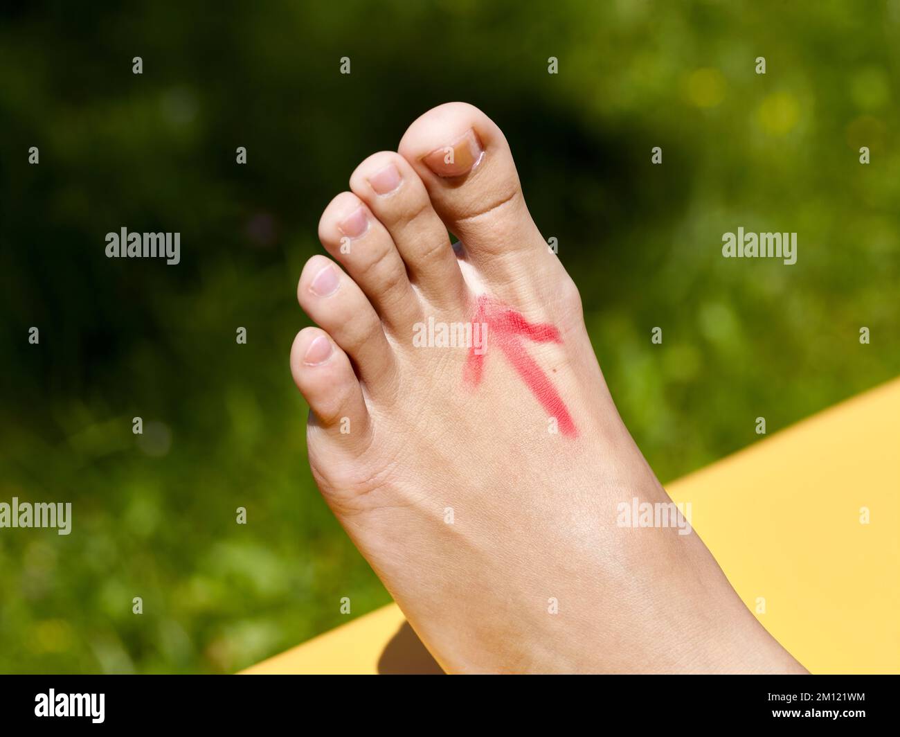 Barefoot walking - close-up of a woman's foot with reflexology zone drawn on the back of the foot in the shape of an arrow Stock Photo