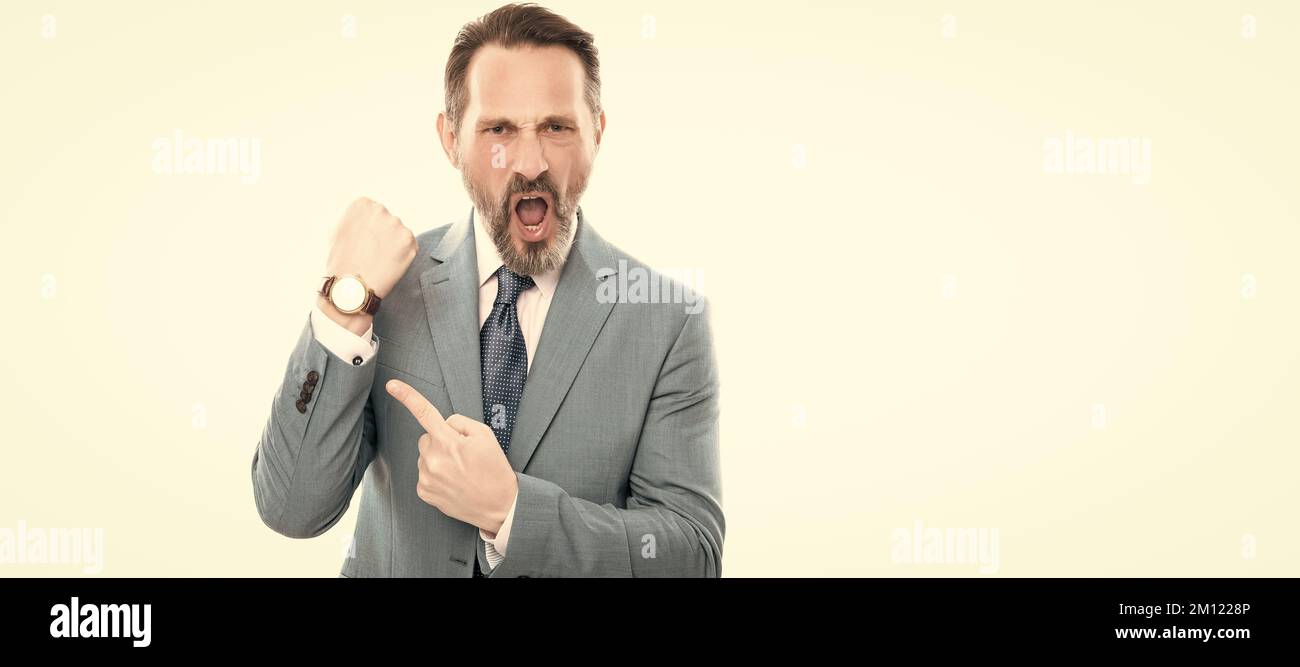 Man face portrait, banner with copy space. angry mature director in suit pointing finger on time on watch isolated on white, late. Stock Photo