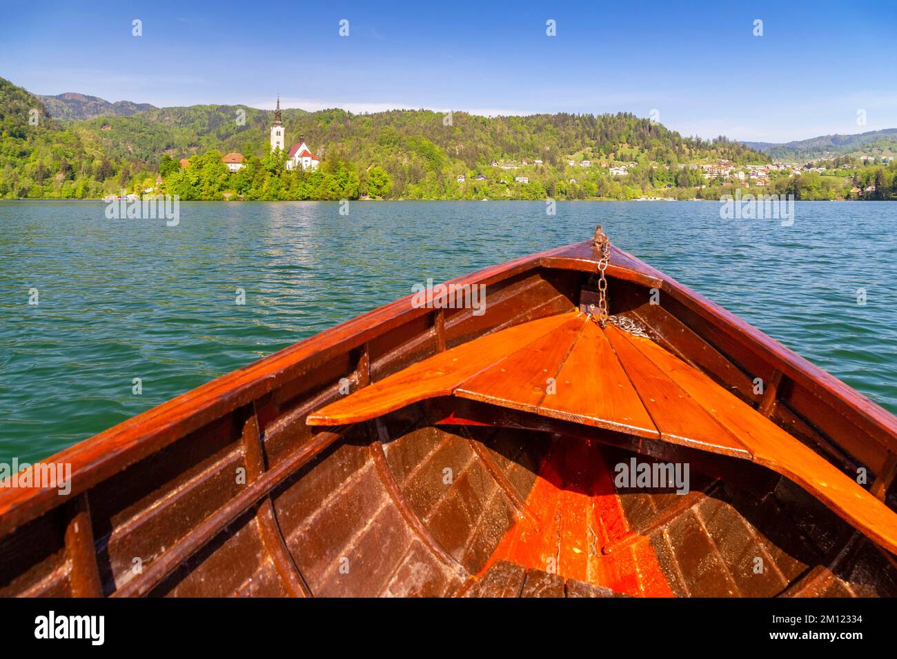 View of Bled church and island on Lake Bled from a typical boat. Bled