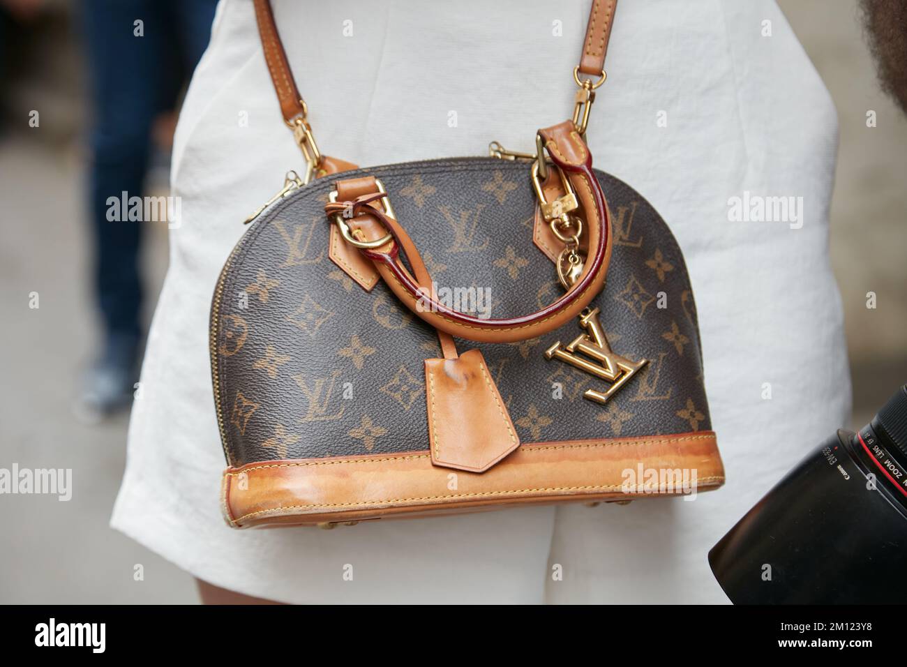 Woman with white Louis Vuitton bag with colorful logos on September 21,  2018 in Milan, Italy Stock Photo