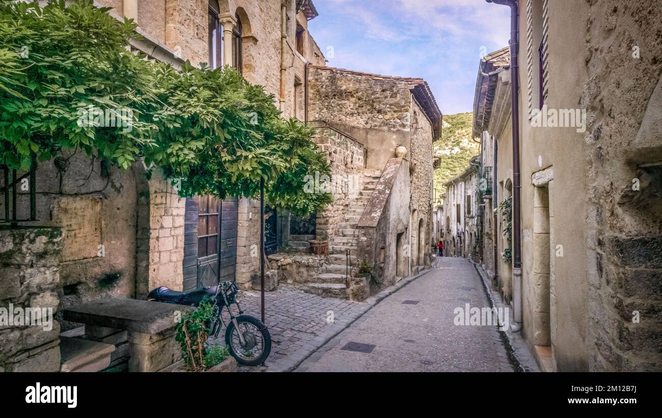 Village street in Saint Guilhem le Désert. Part of the UNESCO World Heritage Site 'Way of Saint James in France' awarded. The village belongs to the Plus Beaux Villages de France. Stock Photo