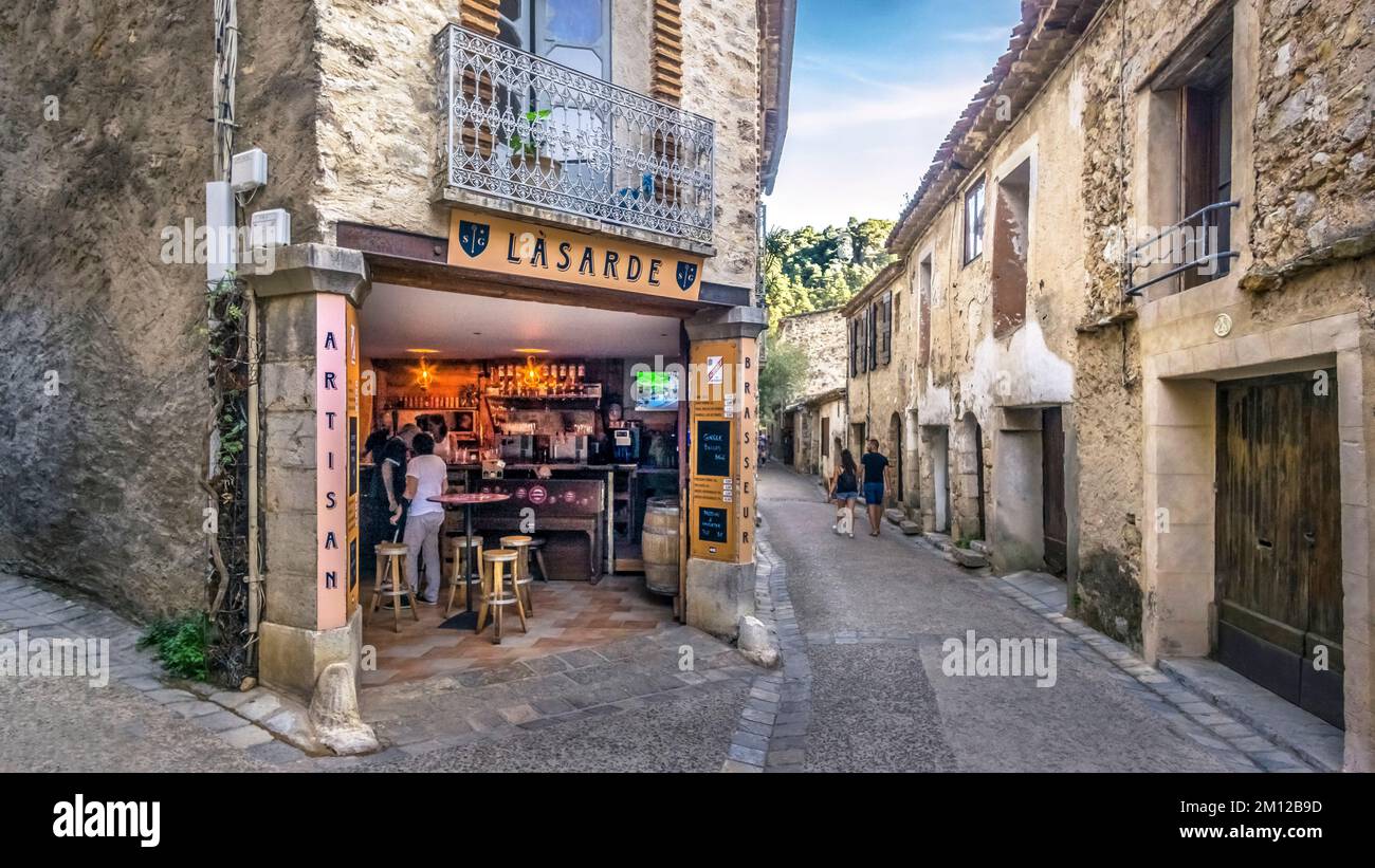 Brasserie in Saint Guilhem le Désert. Part of the World Heritage Site of UNESCO 'Way of Saint James in France' awarded. The village belongs to the Plus Beaux Villages de France. Stock Photo