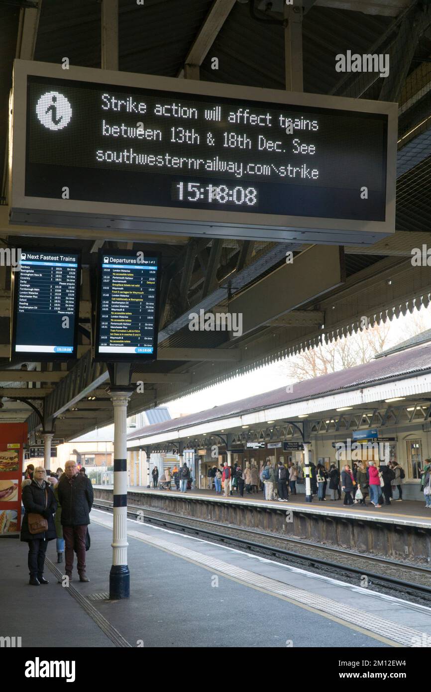 Winchester, UK, 9 December 2022: South Western Railway trains at Winchester station, where notice boards warn of upcoming strikes by the RMT union, which represents drivers and maintenance staff. The strikes from mid-December and over the Christmas period relate to a dispute over pay, pensions and working conditions. Anna Watson/Alamy Live News Stock Photo
