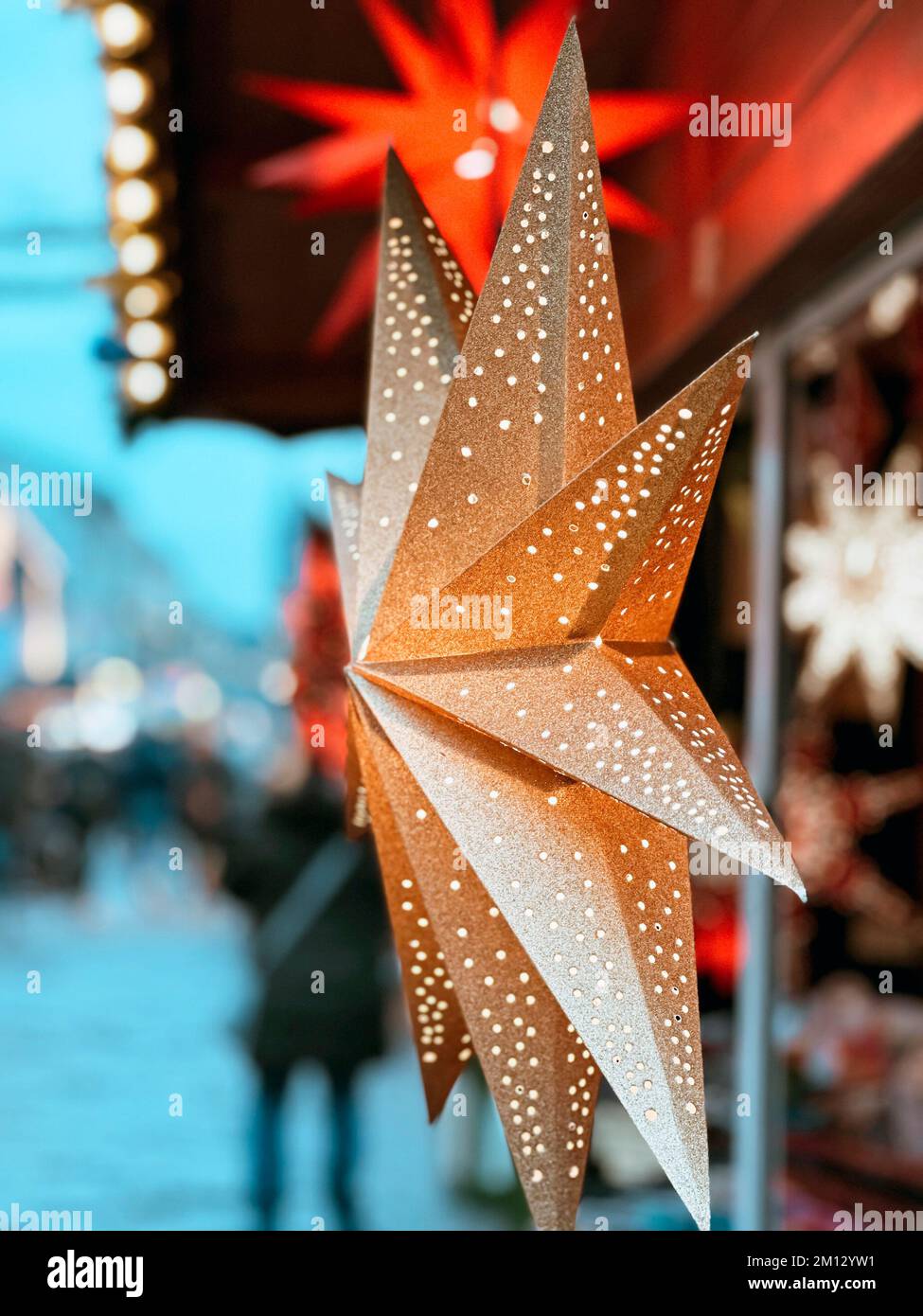 Illuminated poinsettia at a Christmas market in a pedestrian zone closeup Stock Photo