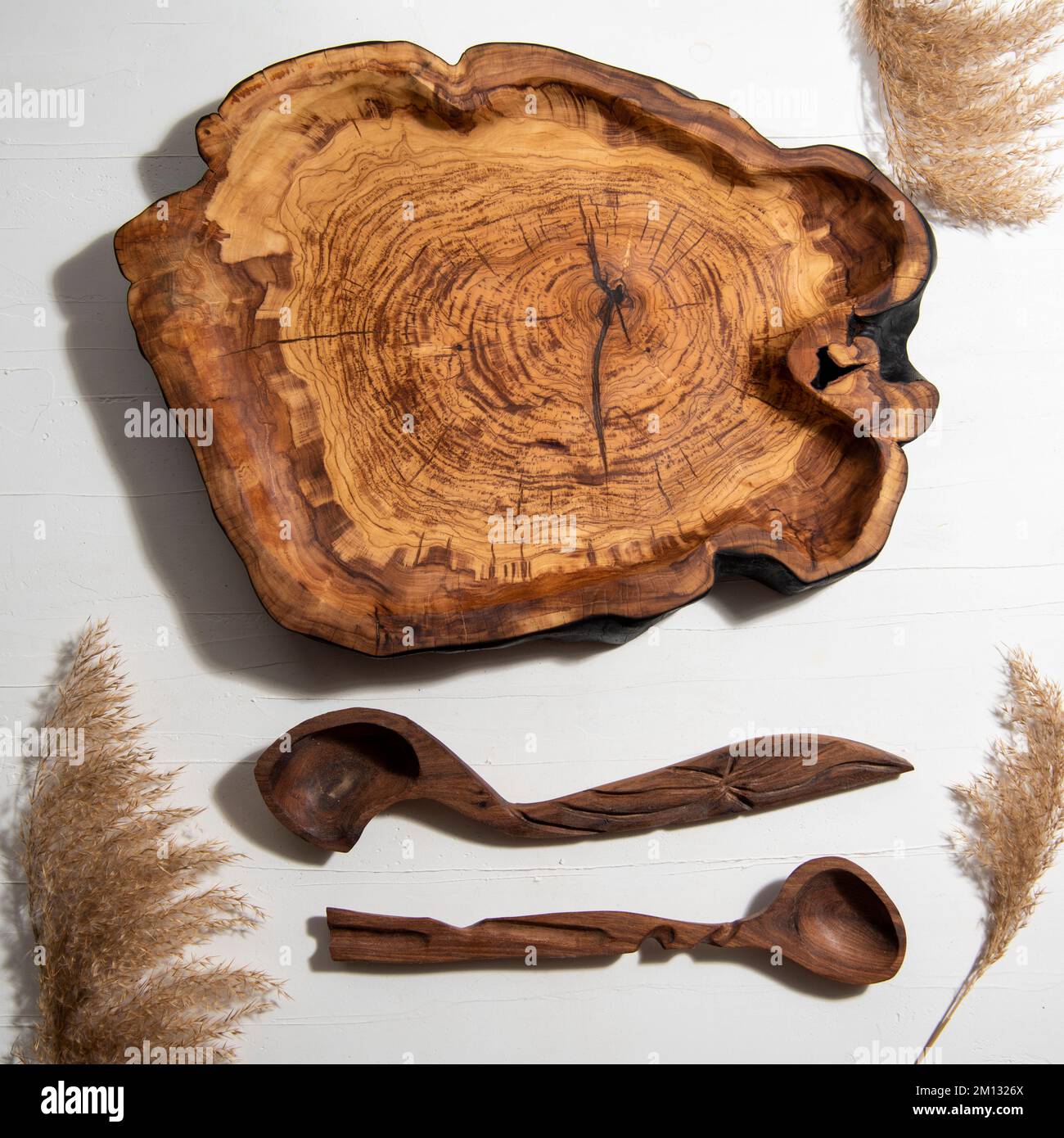 handmade carved wooden kitchen tools on the table Stock Photo