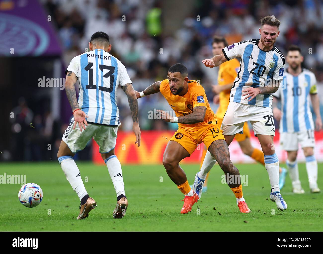 Doha, Qatar, 9th December 2022. Memphis Depay of Netherlands (c) tackled by Alexis Mac Allister of Argentina  (r) and Cristian Romero of Argentina (l) during the FIFA World Cup 2022 match at Lusail Stadium, Doha. Picture credit should read: David Klein / Sportimage Credit: Sportimage/Alamy Live News Stock Photo