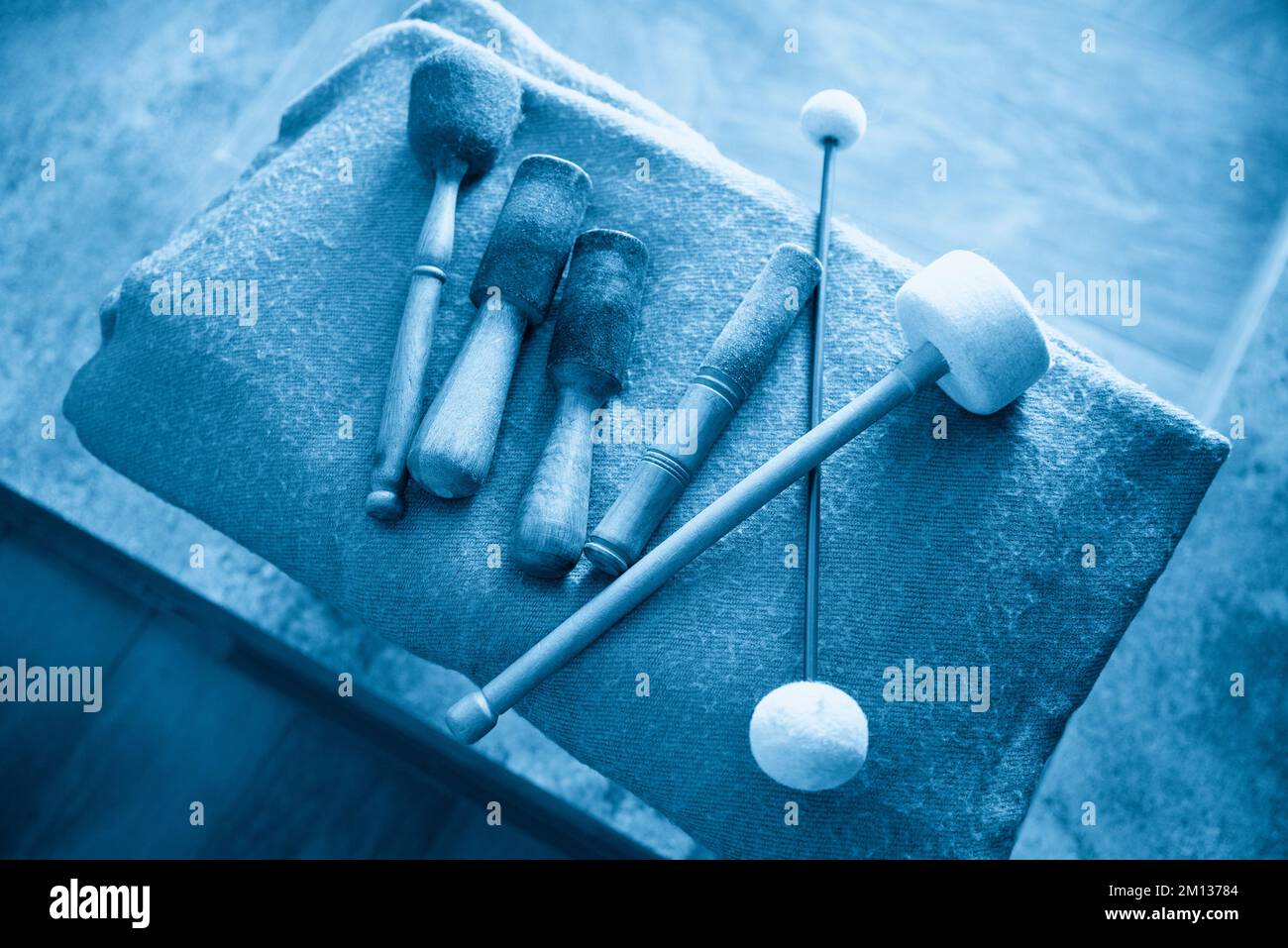 wooden sticks for sound therapy with singing bowls Stock Photo