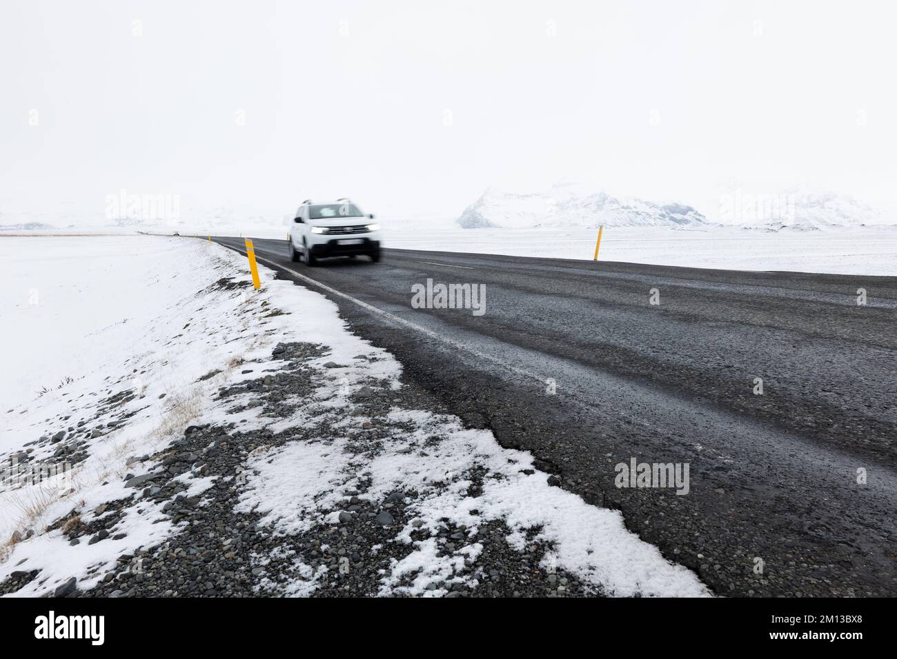 Car Driving On Road LEading Through the Frozen Snowy Landscape of ...