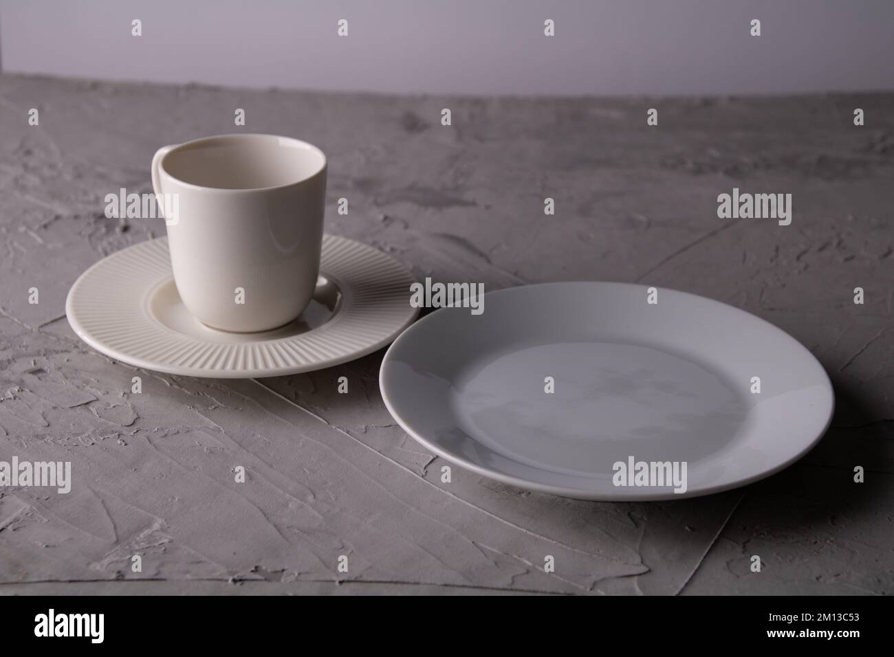 photo of an empty coffee cup and saucer and an empty round plate Stock Photo