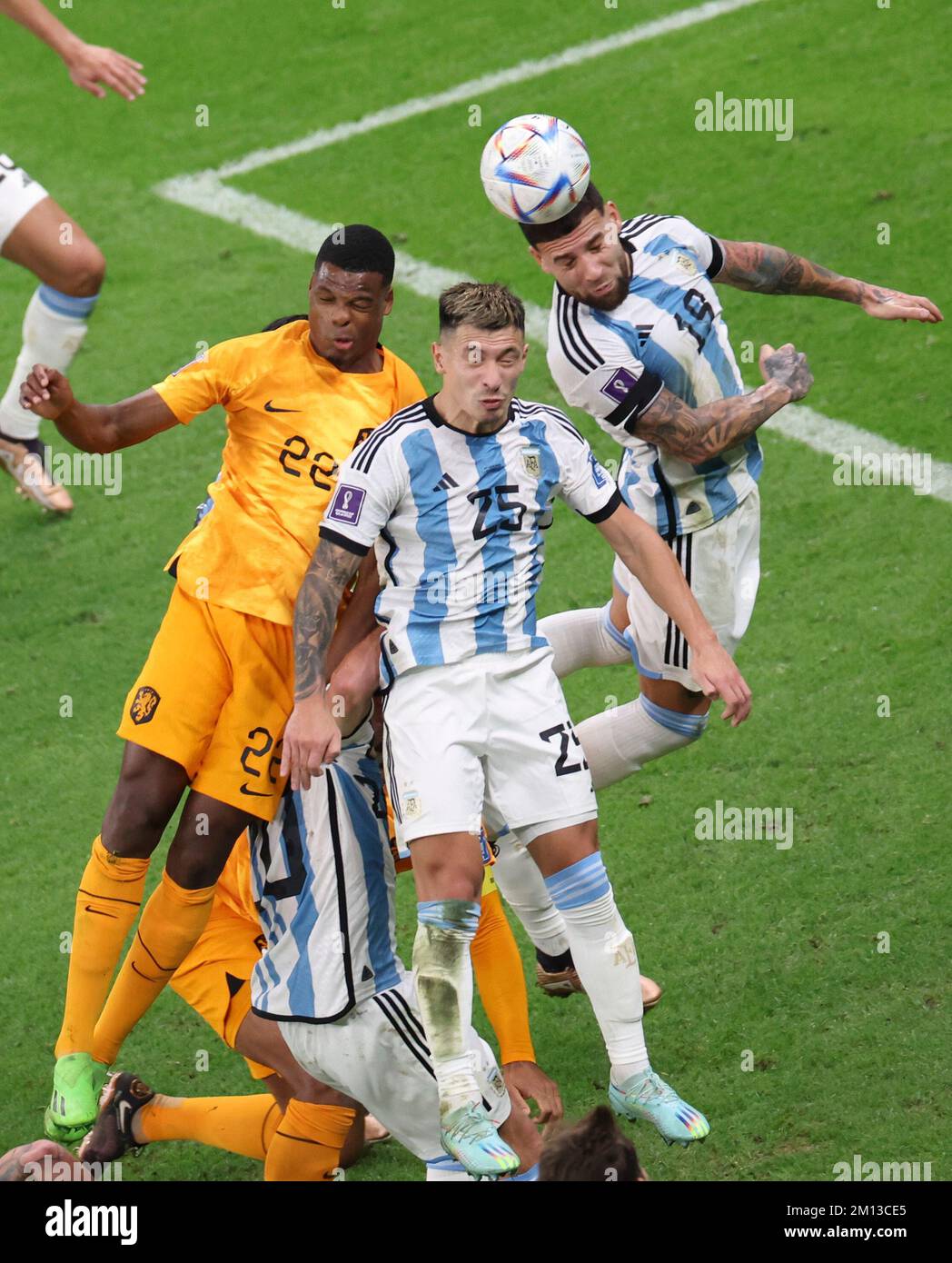 Lusail, Qatar. 9th Dec, 2022. Nicolas Otamendi (1st R) of Argentina heads the ball during the Quarterfinal between the Netherlands and Argentina of the 2022 FIFA World Cup at Lusail Stadium in Lusail, Qatar, Dec. 9, 2022. Credit: Li Gang/Xinhua/Alamy Live News Stock Photo