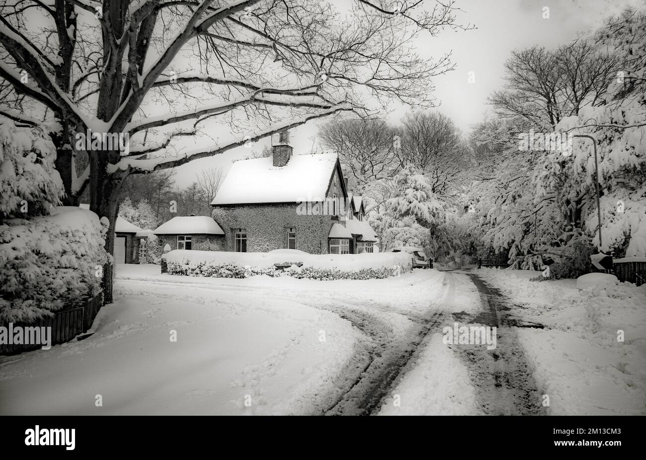Black and white sepia toned photograph of snow covered house in Cannock