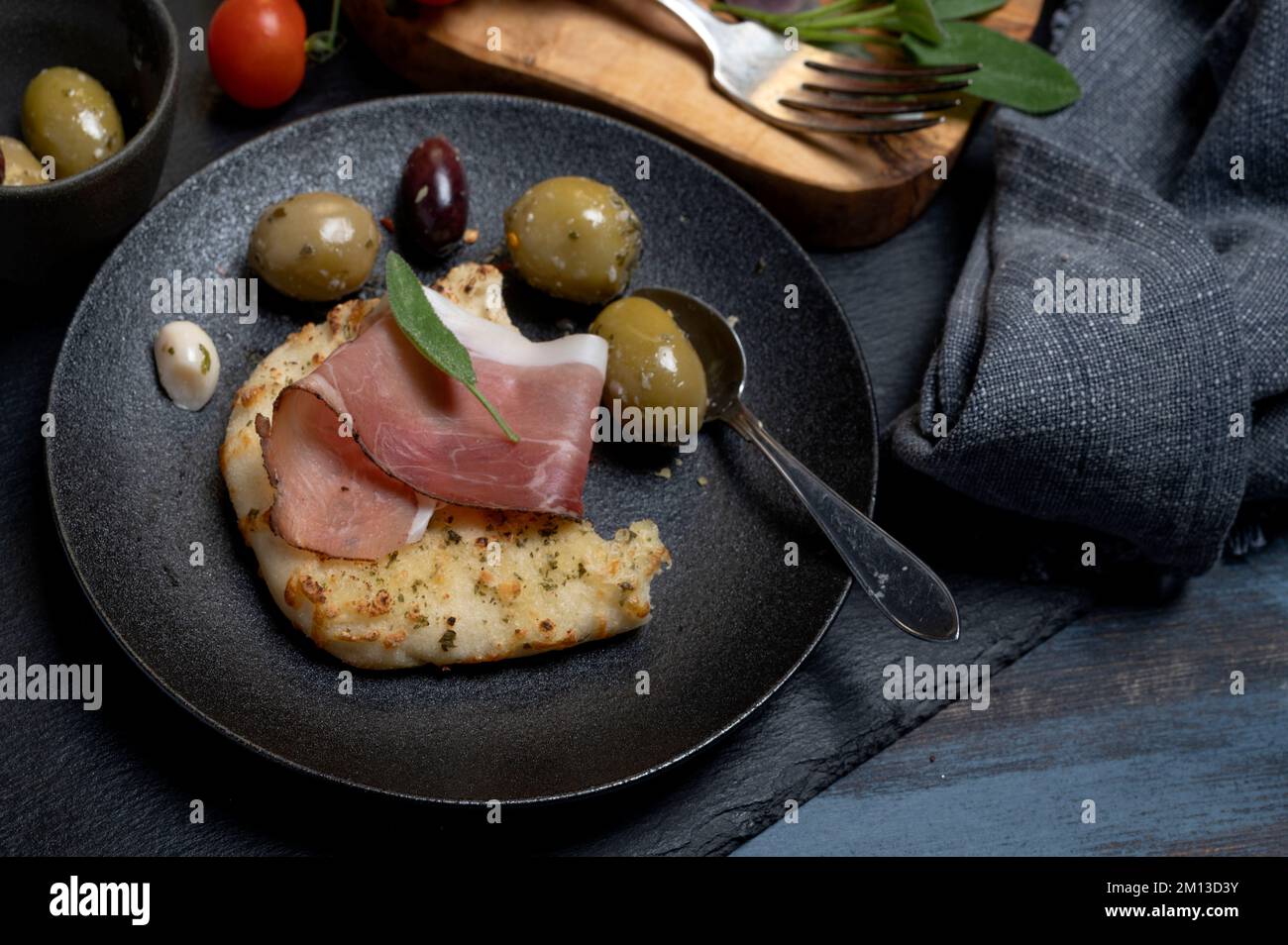 Antipasti plate with focaccia bread olives tomatoes and herbs Stock