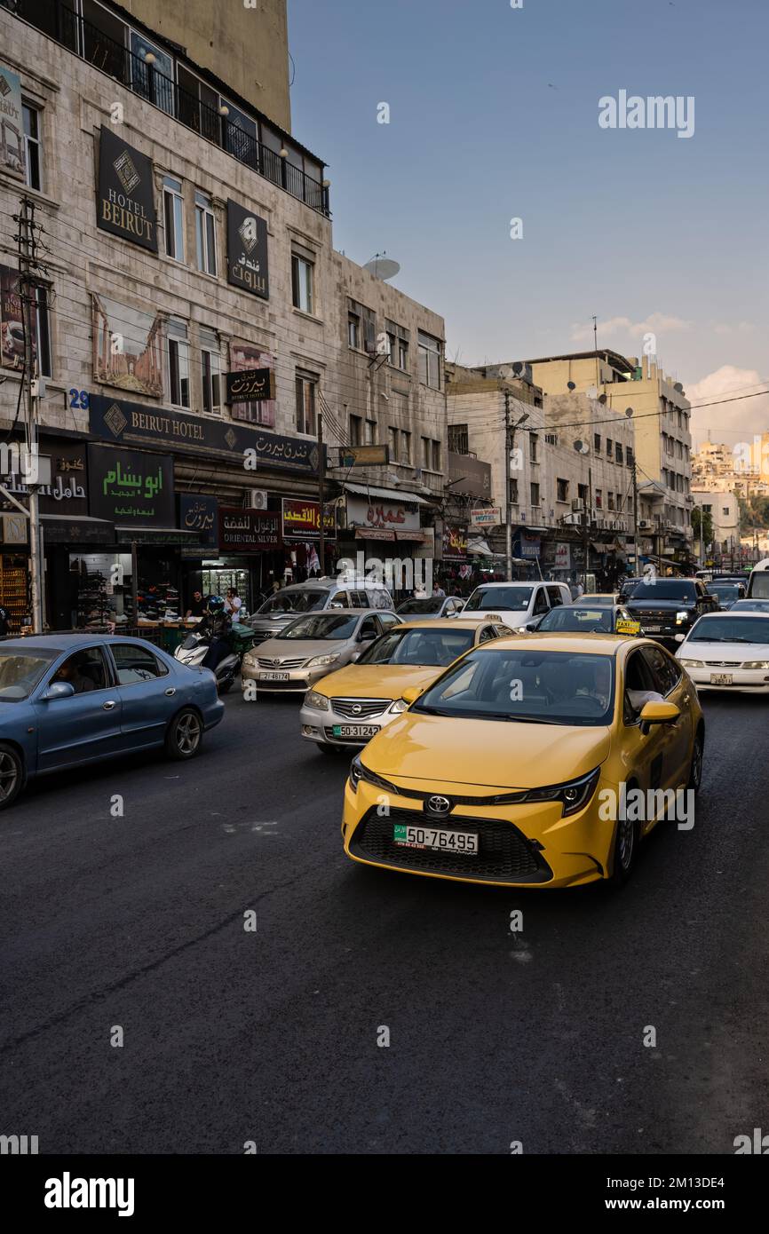 Amman, Jordan - October 26 2022: Yellow Taxi Cab and Traffic on the Al Hashemi Street in Amman City. Stock Photo