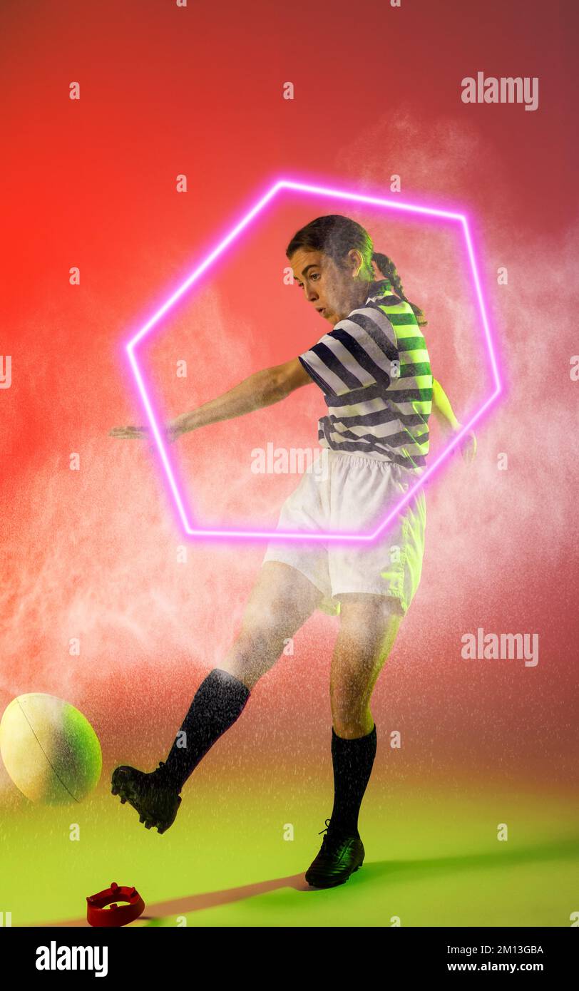 Illuminated hexagon over caucasian female rugby player kicking ball amidst smoke, copy space Stock Photo