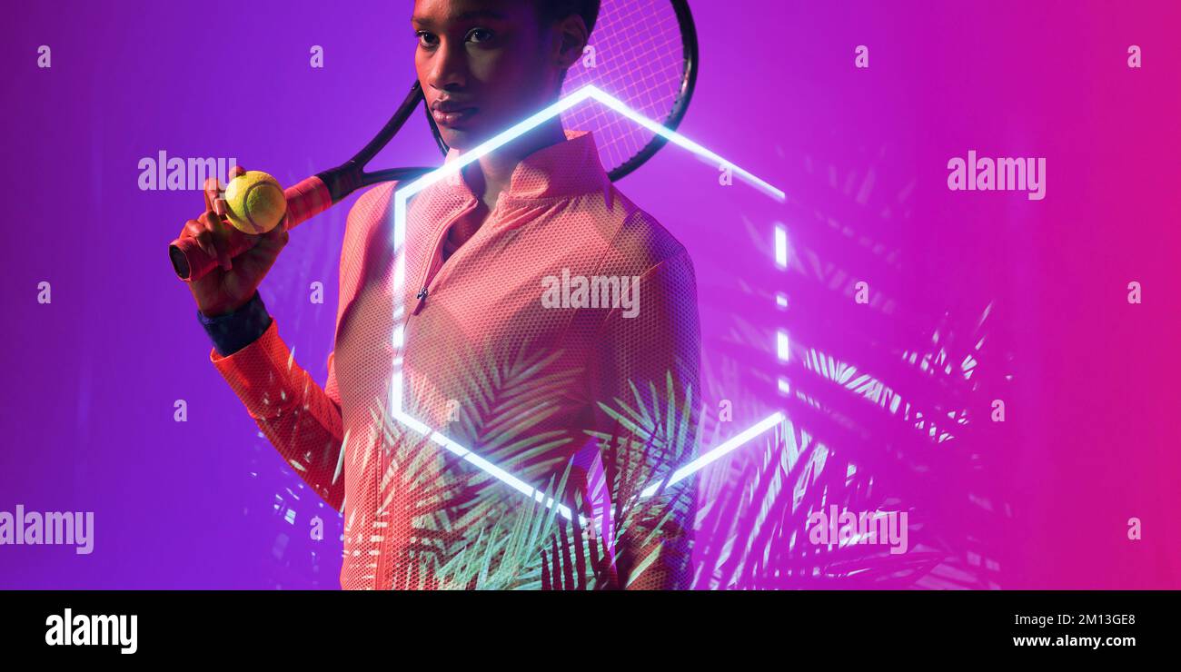 African american female tennis player holding ball and racket by