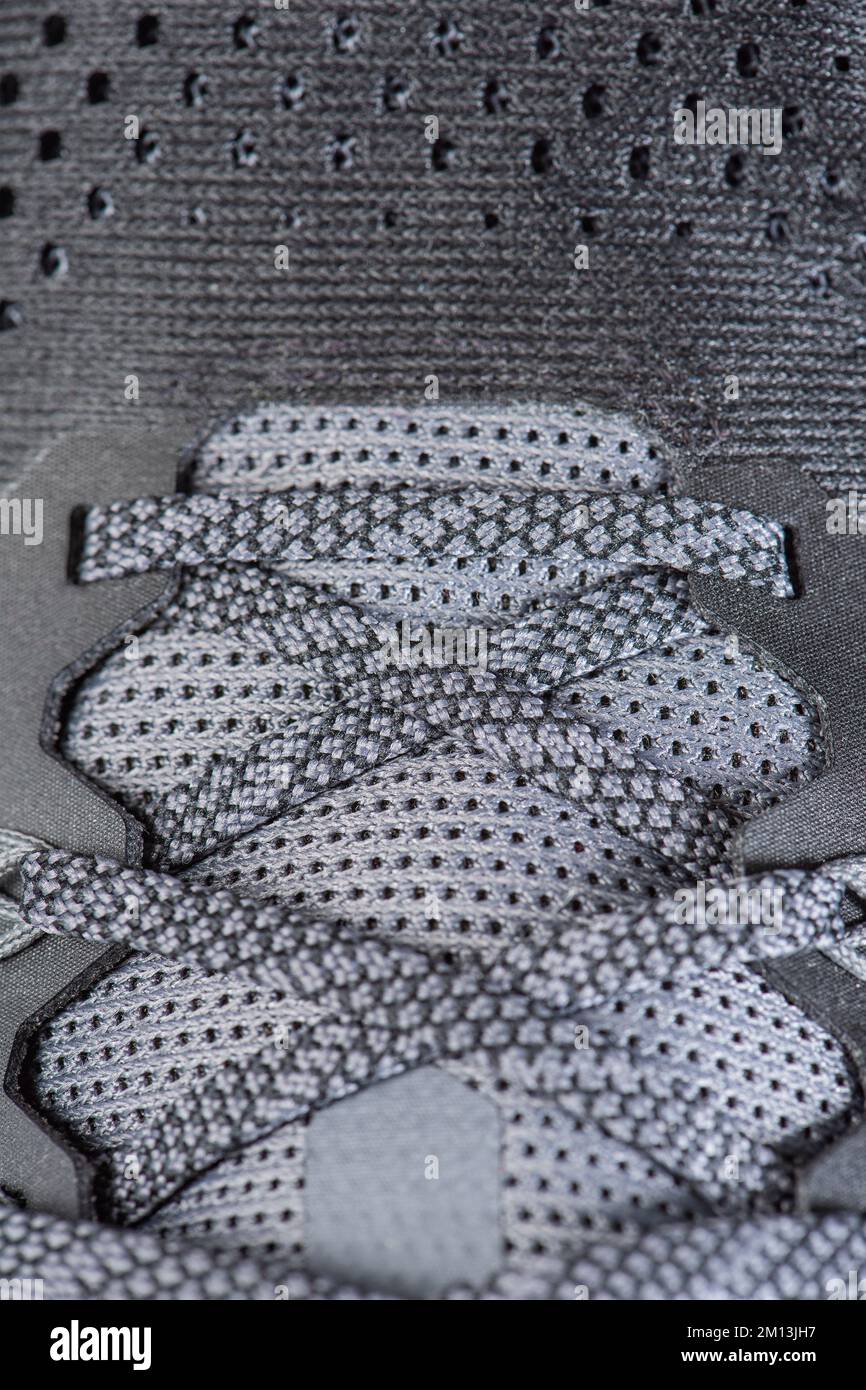 Sneakers close-up. Shoelaces of new sports shoes in gray, lacing sneakers close-up, top view. Mesh elastic laces for fitness. Sport and active Stock Photo