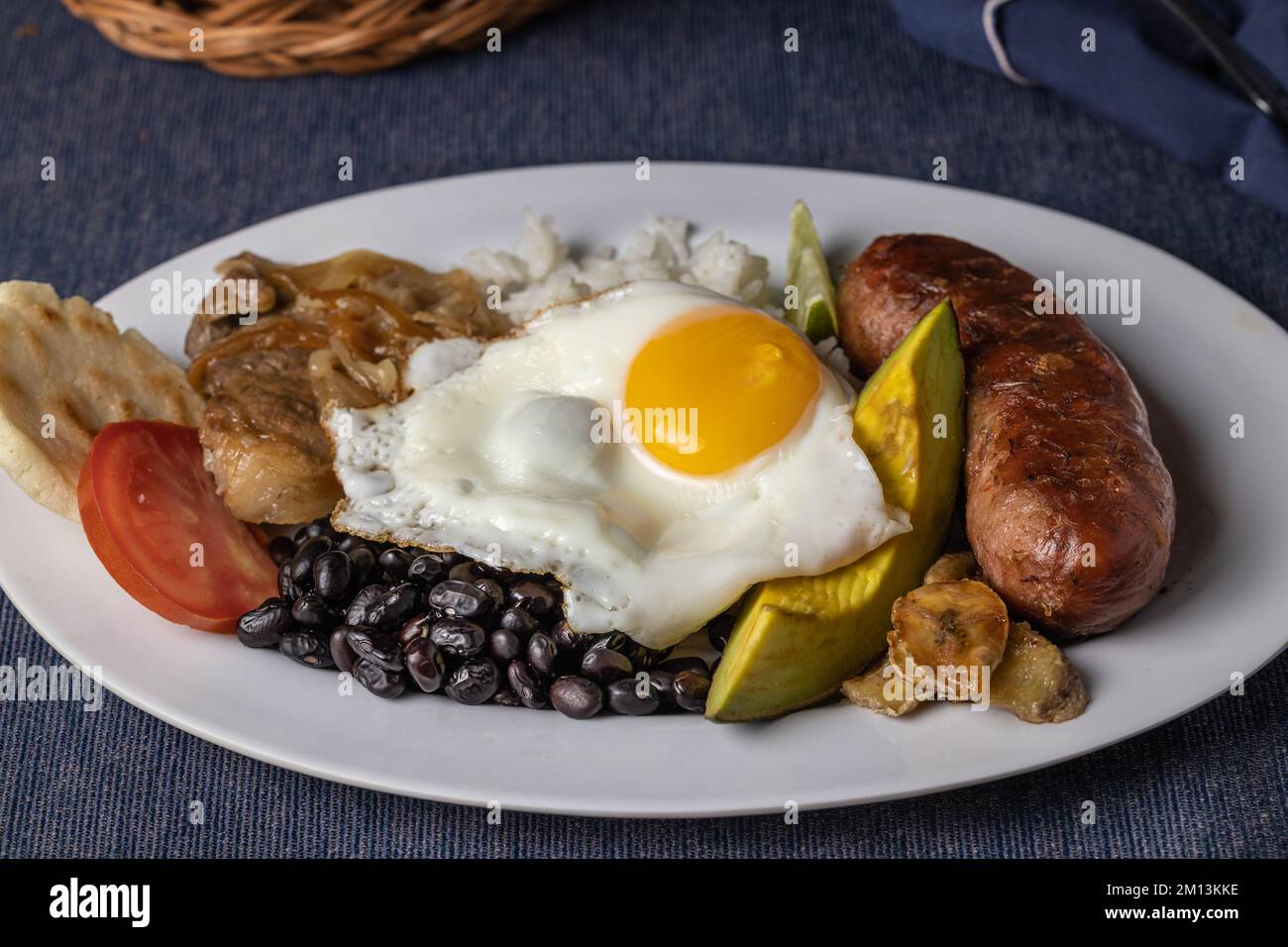 Bandeja paisa, typical food of Colombia in white plate. Stock Photo