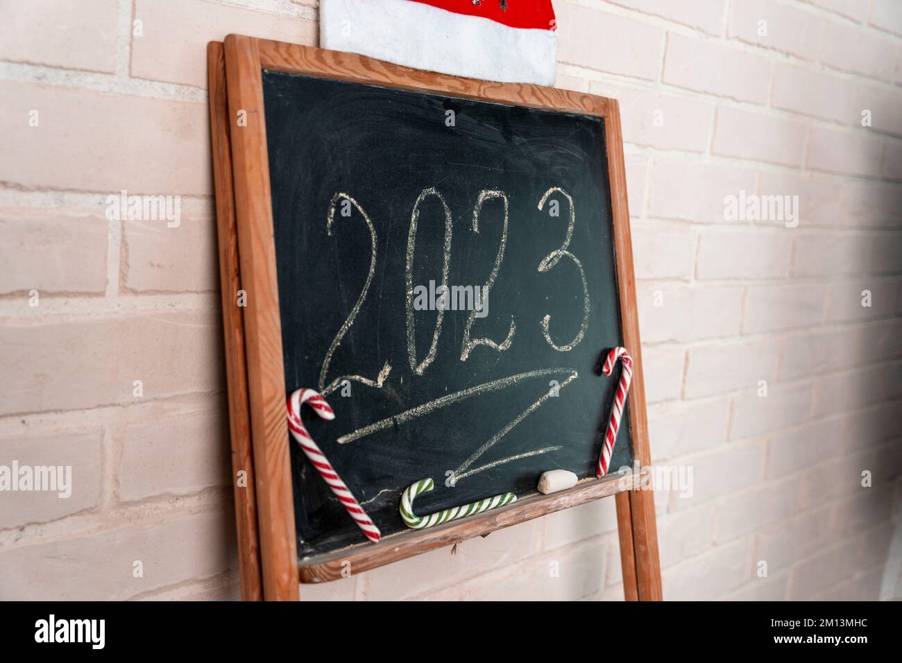 a black slate on which the year 2023 is written in chalk. Happy New Year. Stock Photo