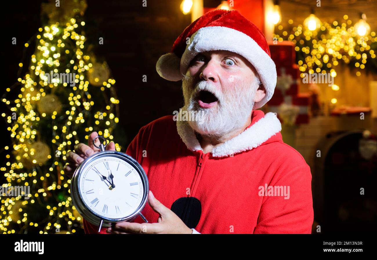 Merry Christmas and Happy new year. Surpised Santa Claus with old clock
