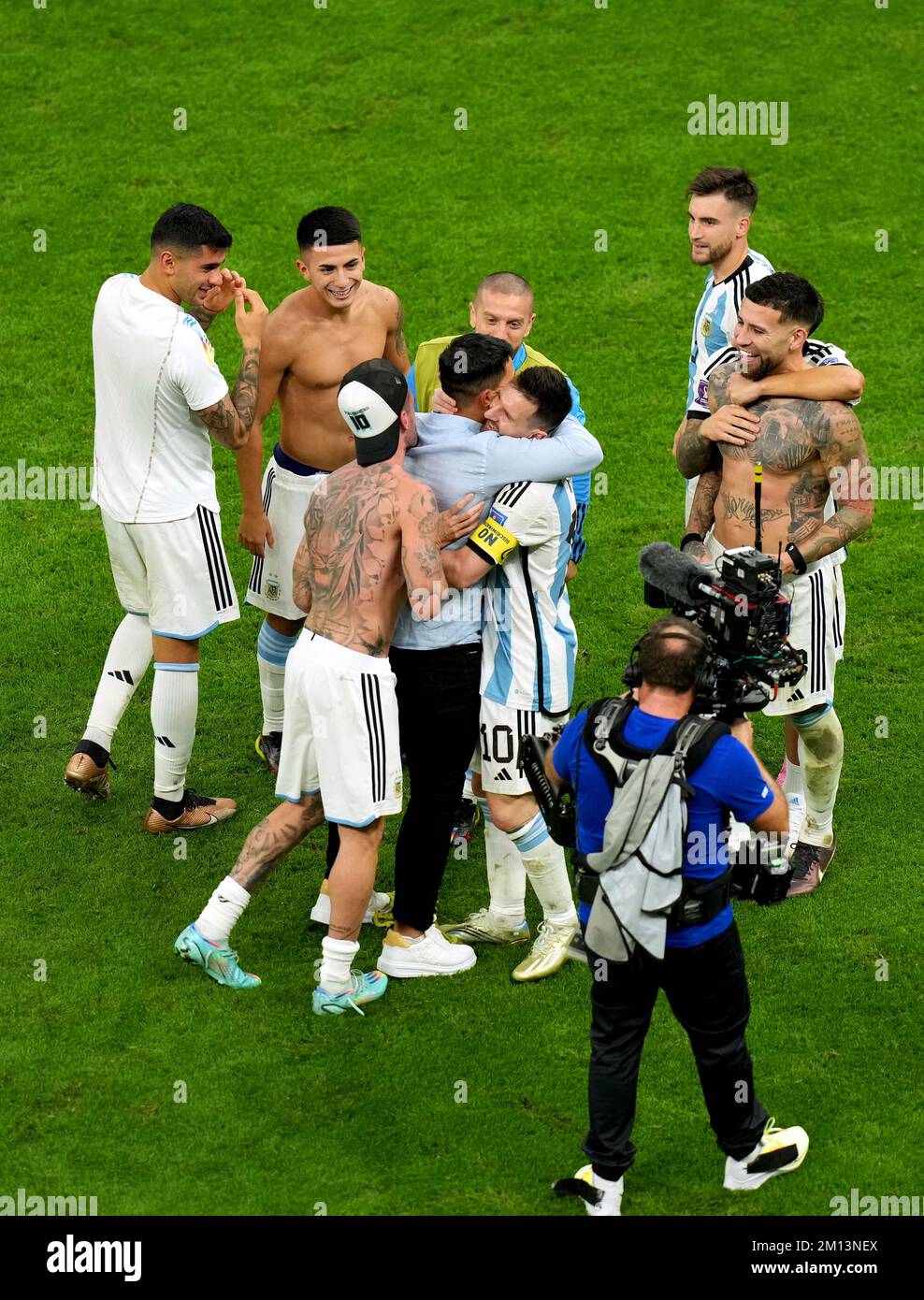 Former Argentina player Sergio Aguero hugs Lionel Messi following Argentina's victory in the penalty shoot-out of the FIFA World Cup Quarter-Final match at the Lusail Stadium in Lusail, Qatar. Picture date: Friday December 9, 2022. Stock Photo