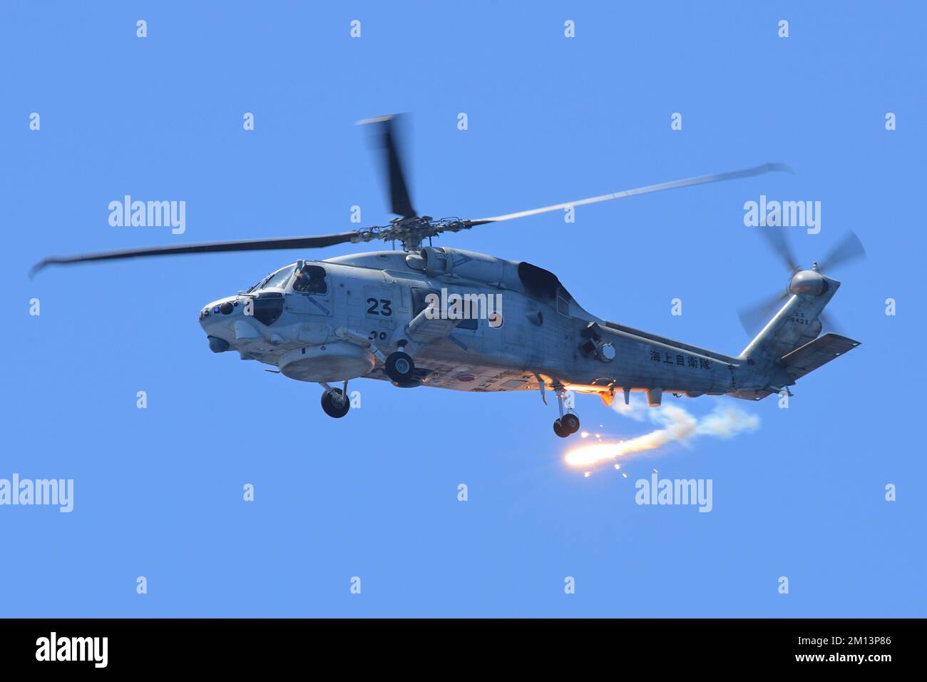 Kyoto Prefecture, Japan - July 25, 2014: Japan Maritime Self-Defense Force Sikorsky SH-60K Seahawk anti-submarine helicopter deploying IR flare. Stock Photo