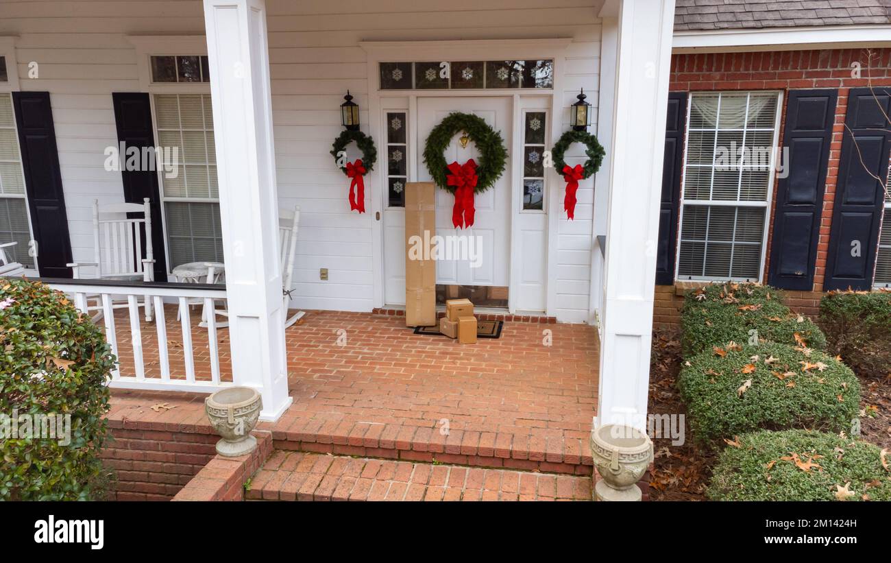 Shipping boxes on front porch of home during holiday season Stock Photo
