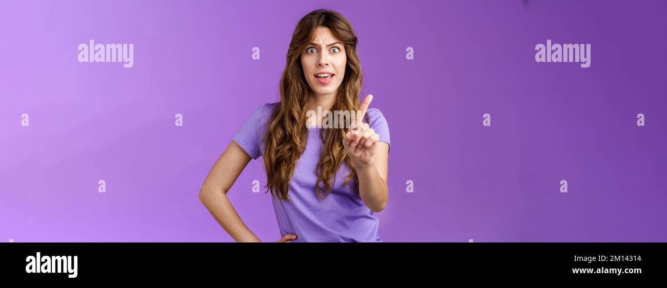 Displeased offended serious-looking assertive woman forbid express dislike and disapproval frowning annoyed shaking index finger prohibit refusing Stock Photo