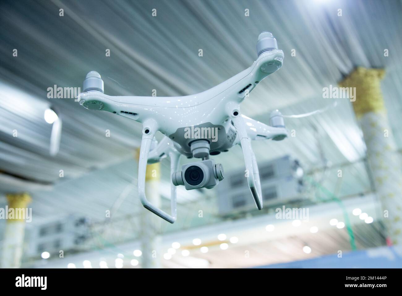 A closeup of a white drone flying inside a building hall in Bengaluru,India on June 6,2018 Stock Photo